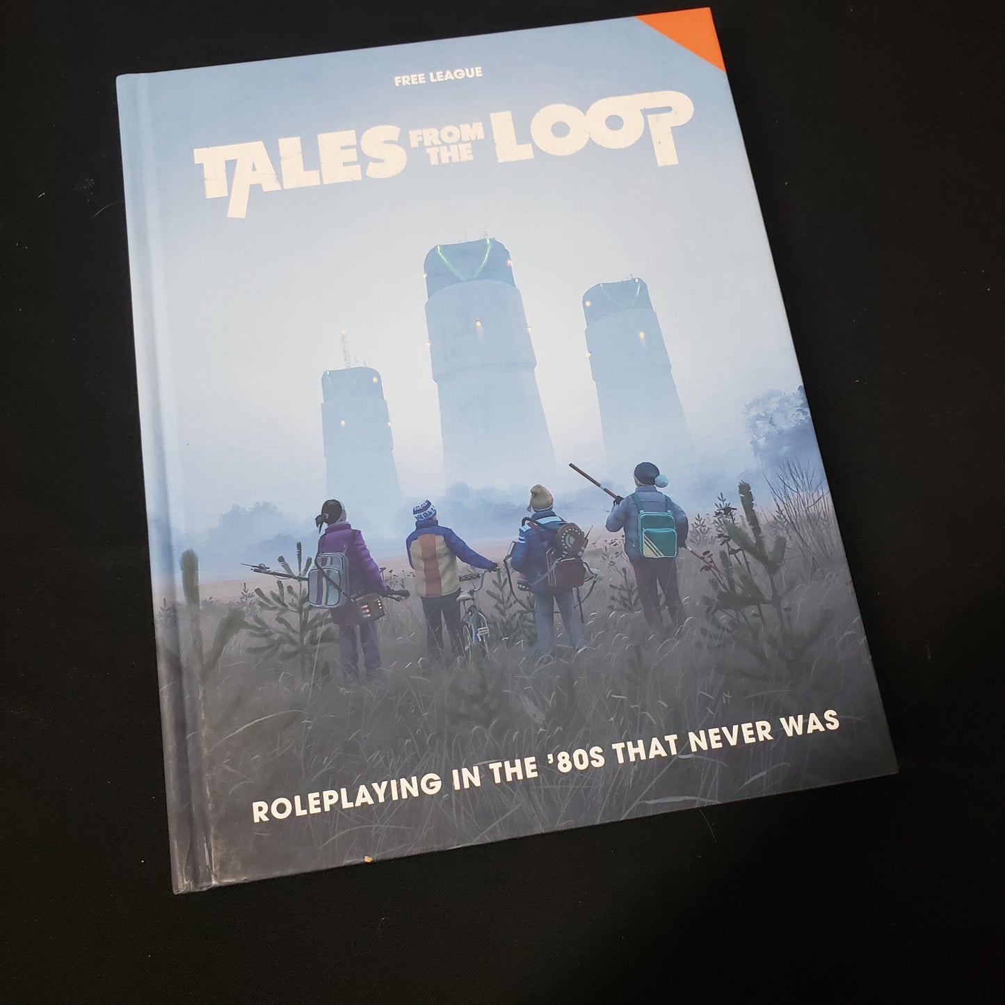 Image shows the front cover of the core rulebook for the Tales from the Loop roleplaying game
