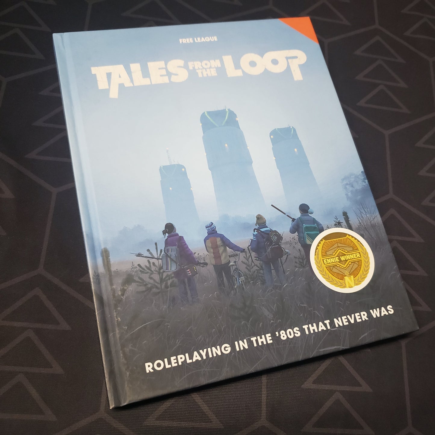 Image shows the front cover of the core rulebook for the Tales from the Loop roleplaying game