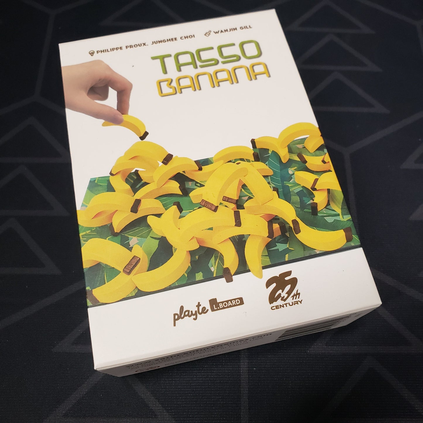 Image shows the front cover of the box of the Tasso Banana board game
