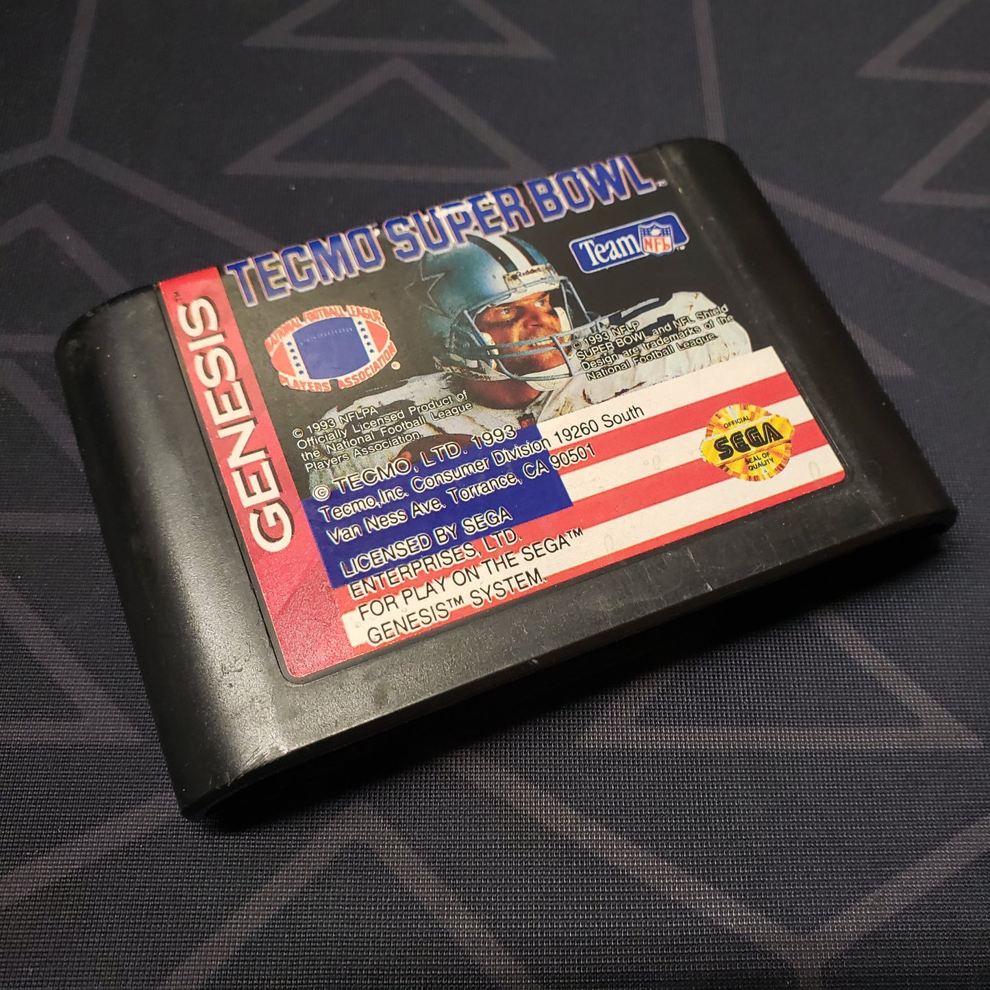 Image shows the front of the cartridge for the video game Tecmo Super Bowl for Sega Genesis