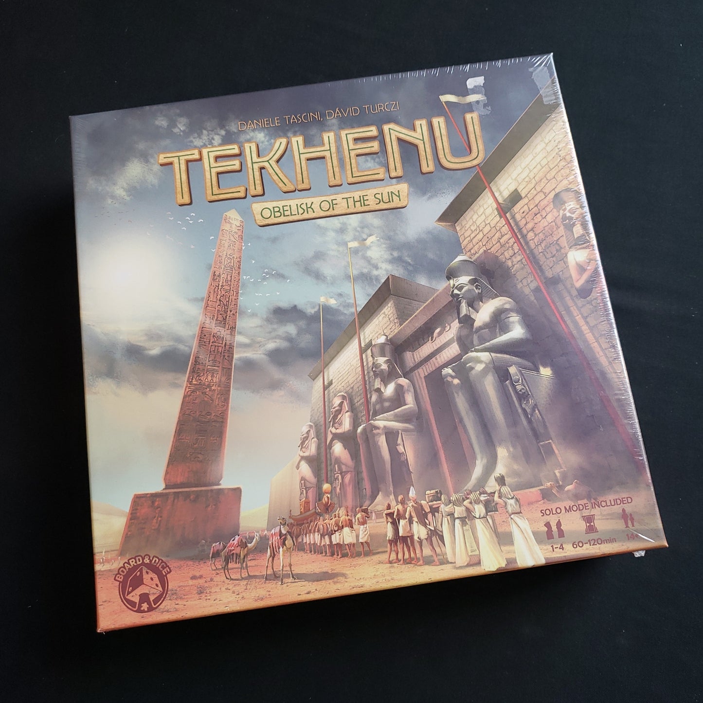 Image shows the front cover of the box of the Tekhenu: Obelisk of the Sun board game