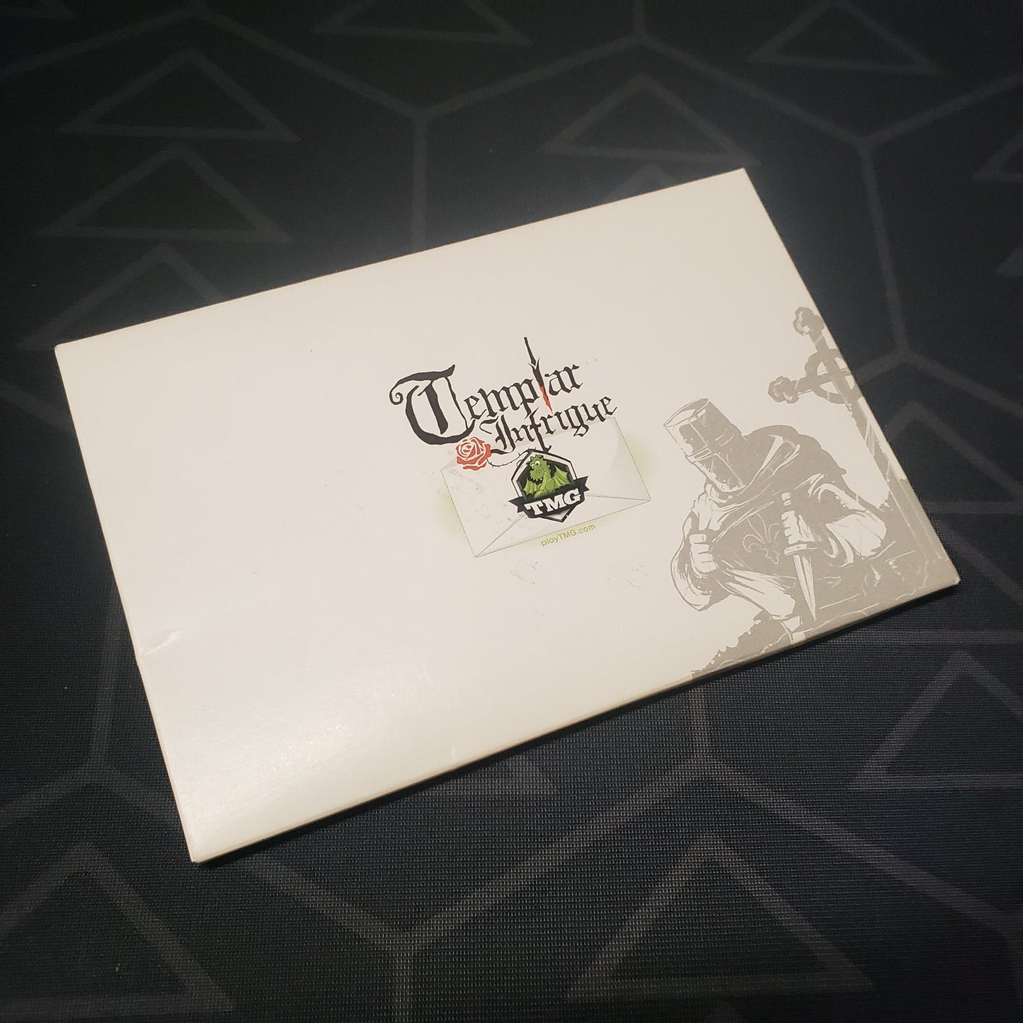 Image shows the front cover of the box for the Templar Intrigue card game