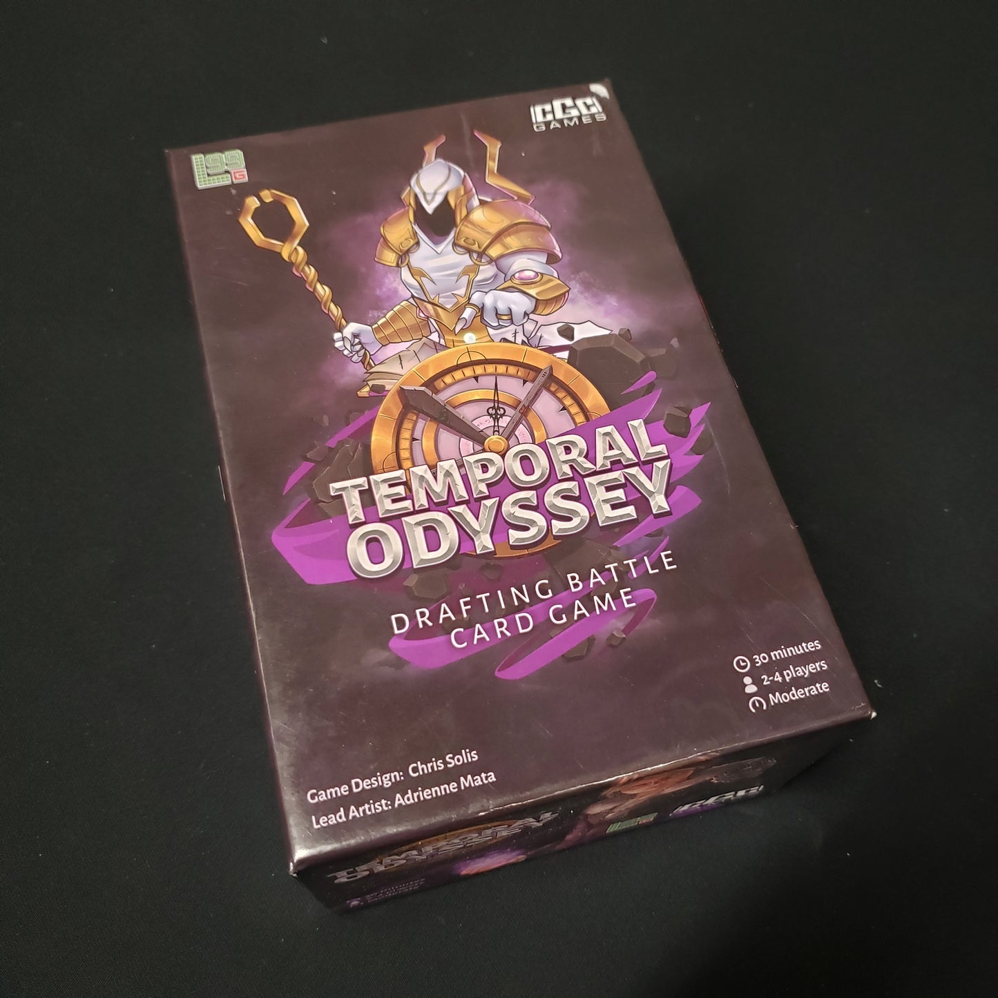 Image shows the front cover of the box of the Temporal Odyssey card game