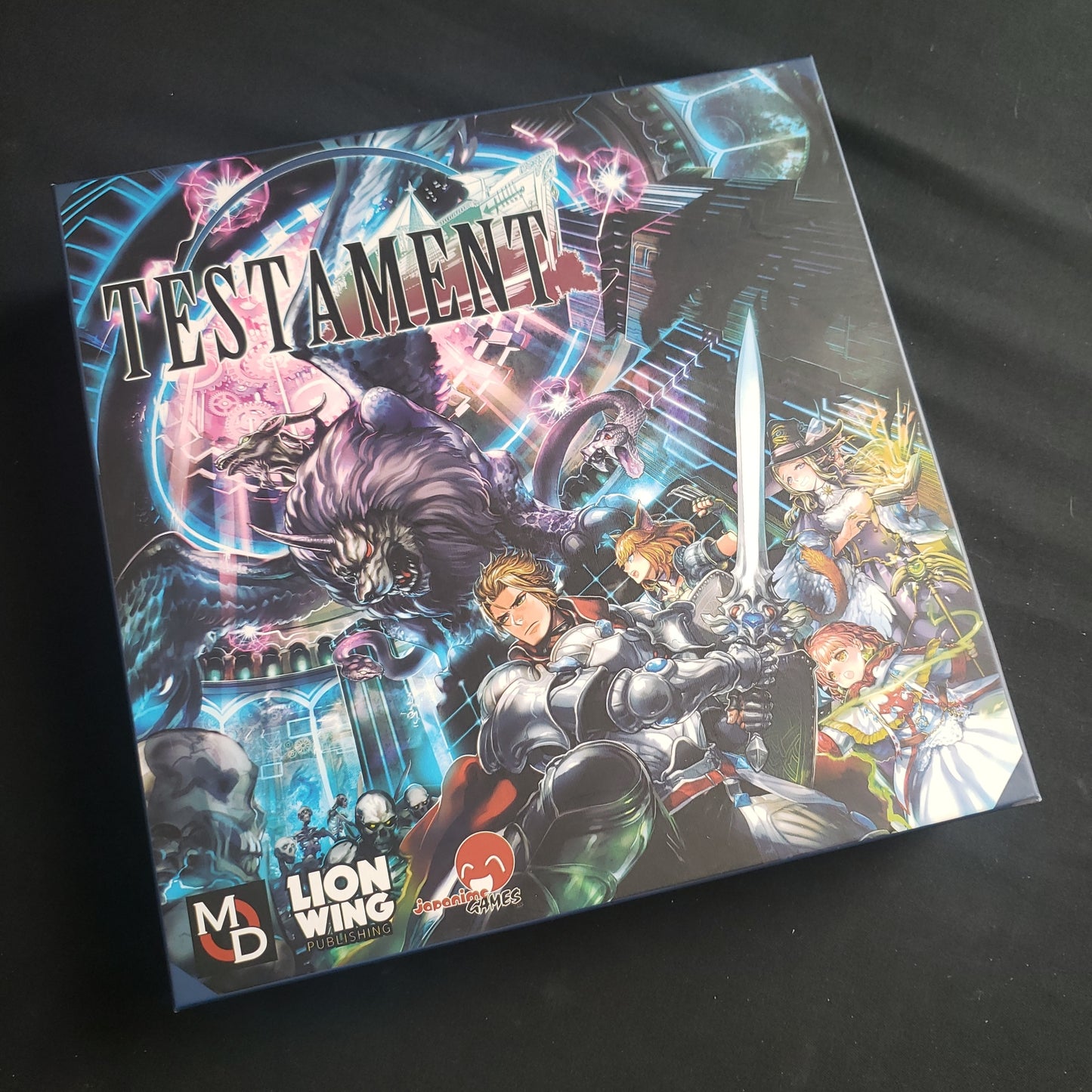 Image shows the front cover of the box of the Testament card game