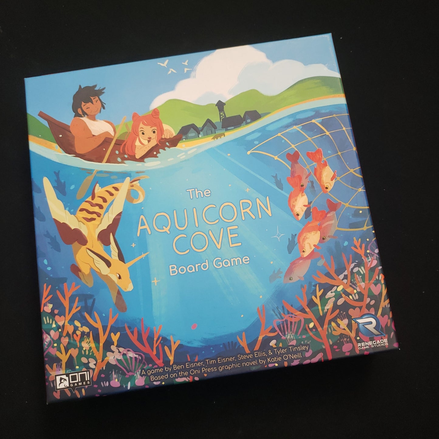 Image shows the front cover of the box of the Aquicorn Cove board game