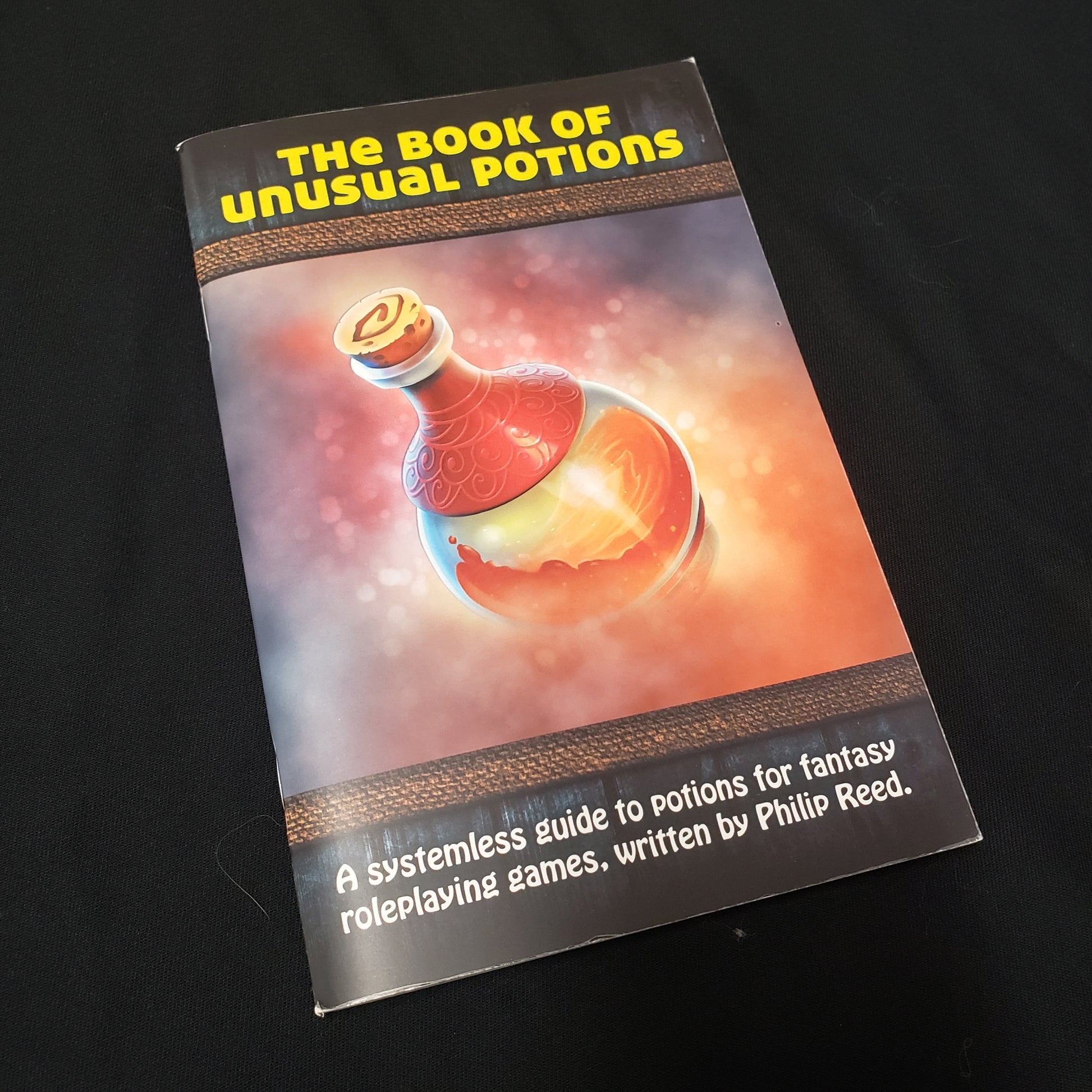 Image shows the front cover of the Book of Unusual Potions roleplaying game book