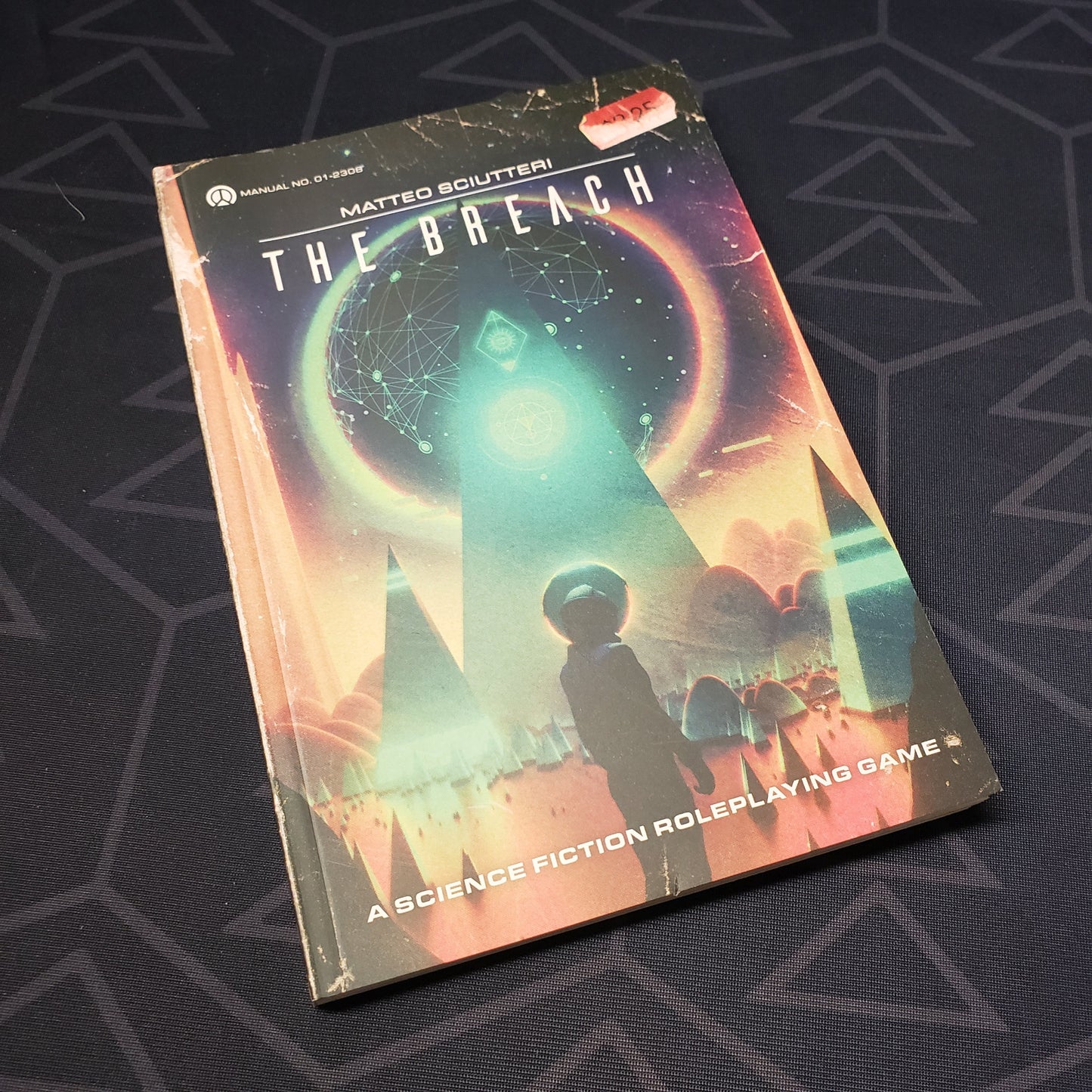 Image shows the front cover of the core rulebook for the roleplaying game The Breach