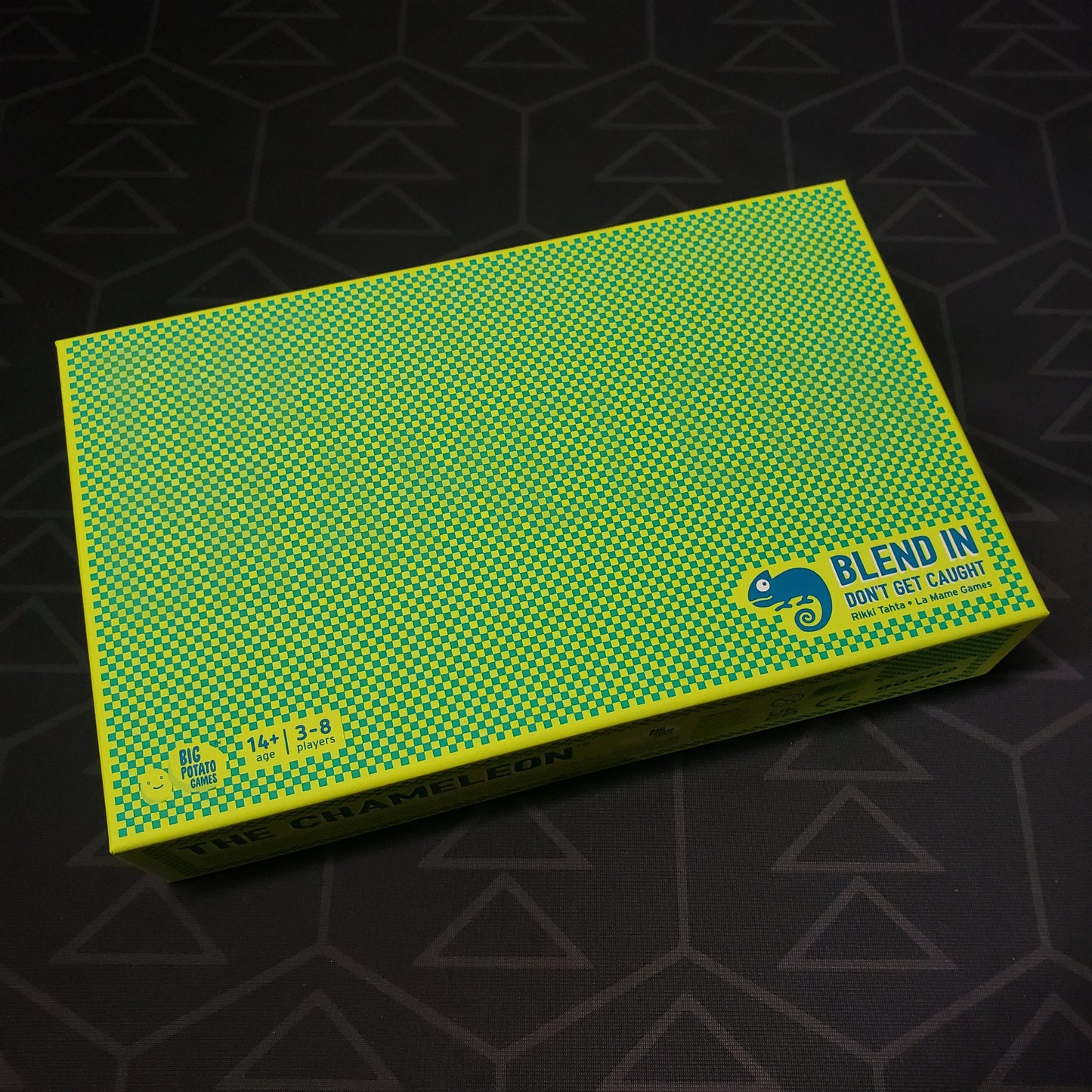 Image shows the front cover of the box for the Chameleon card game