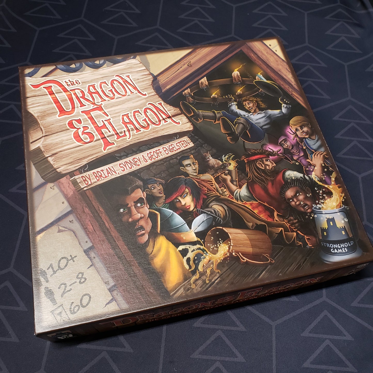 Image shows the front cover of the box for the Dragon & Flagon board game