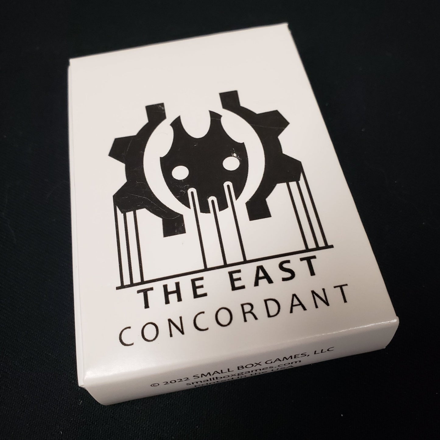 Image shows the front cover of the box of the East: Concordant card game
