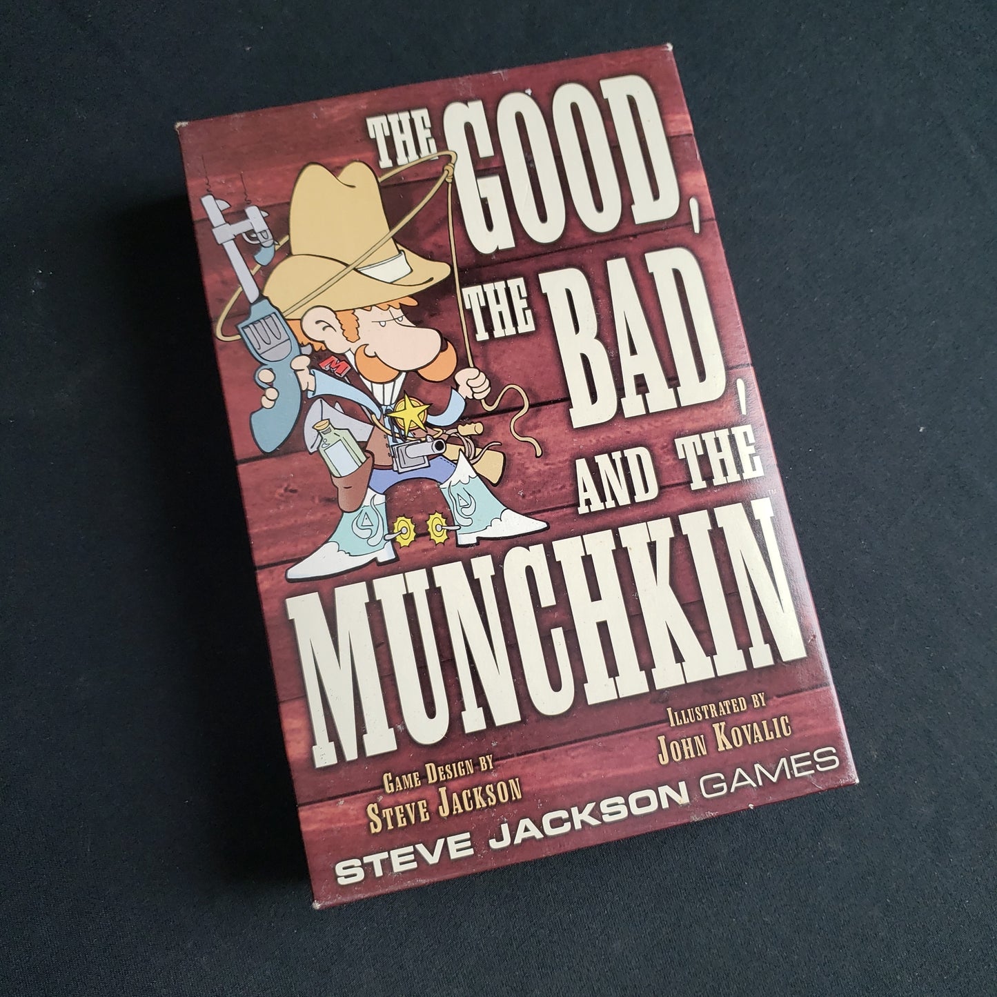 Image shows the front cover of the box of the Good, the Bad, and the Munchkin card game