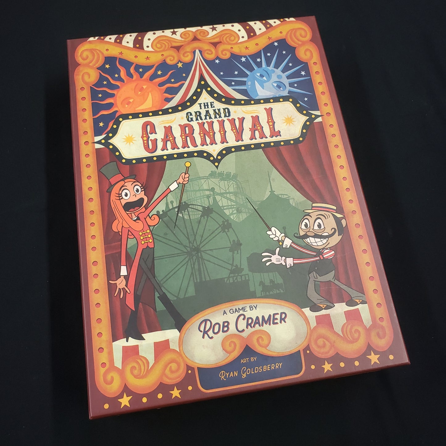 Image shows the front cover of the box of the Grand Carnival board game