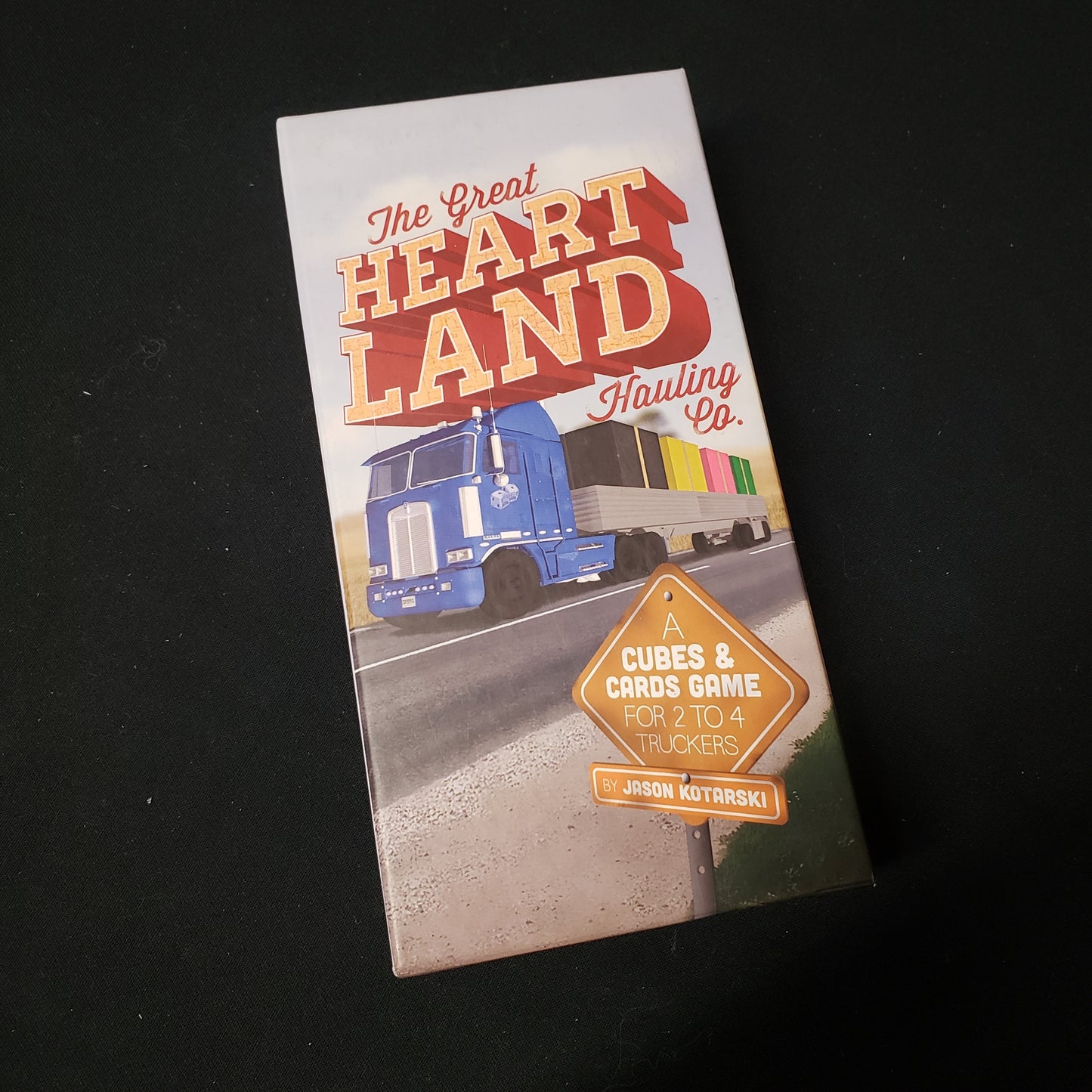 Image shows the front cover of the box of the Great Heartland Hauling Co. board game