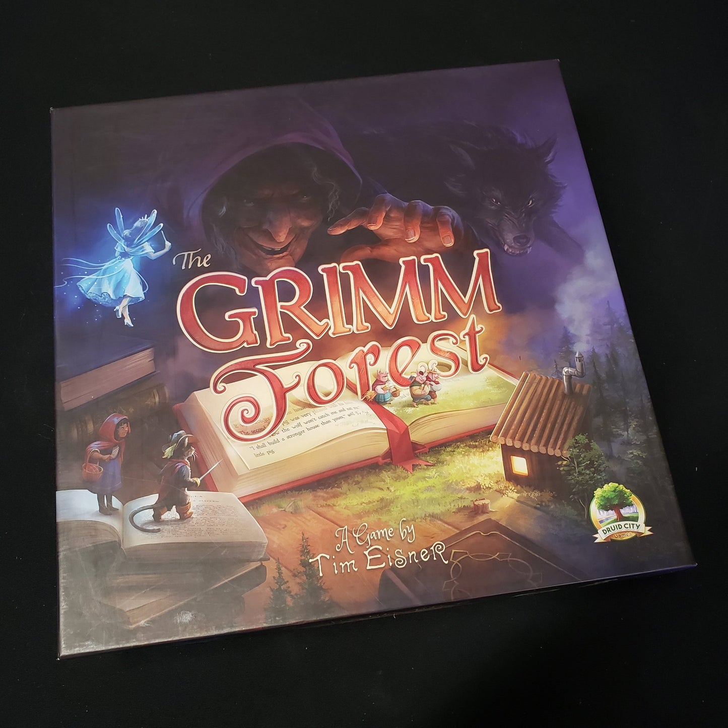 Image shows the front cover of the box of the Grimm Forest board game