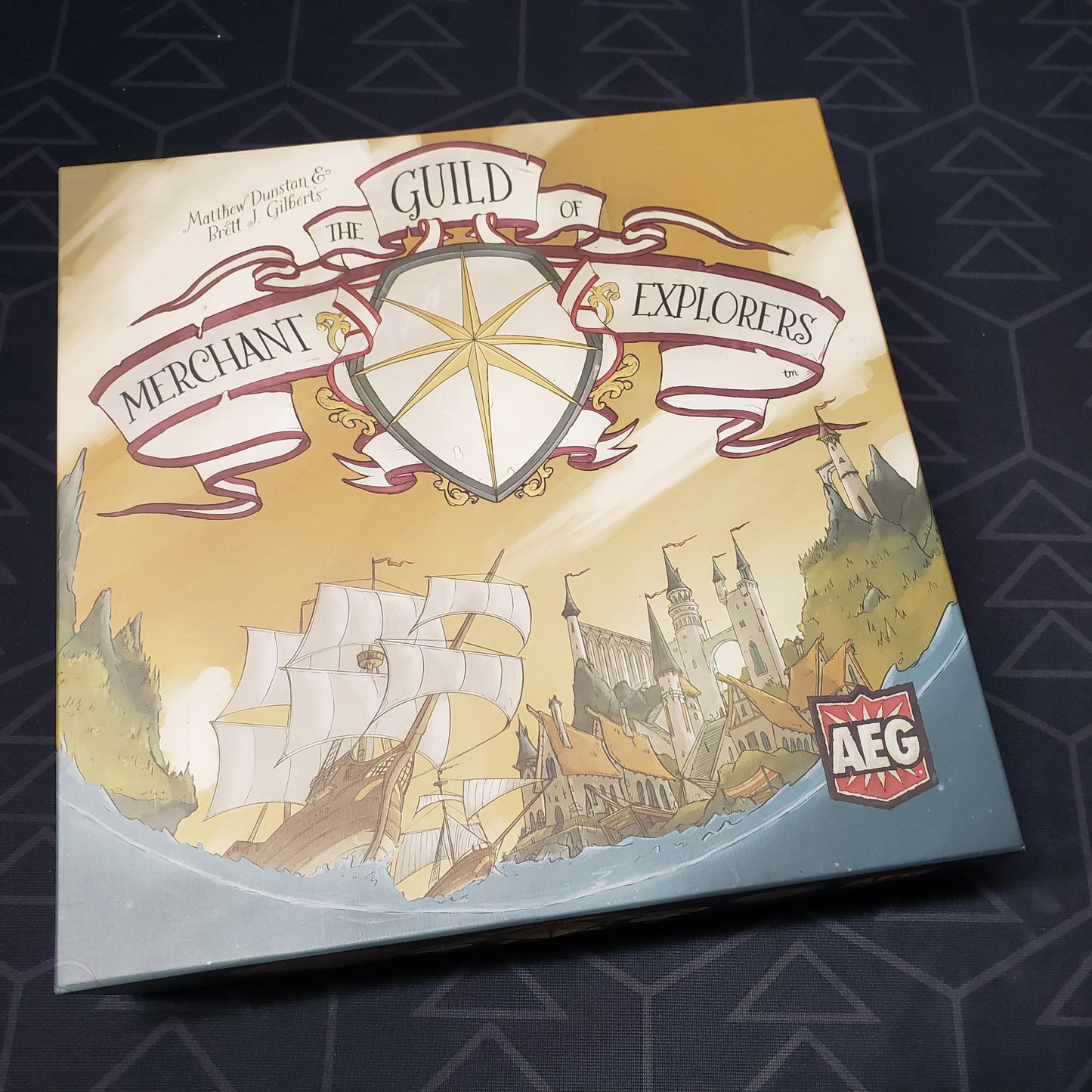 Image shows the front cover of the box for the Guild of Merchant Explorers board game