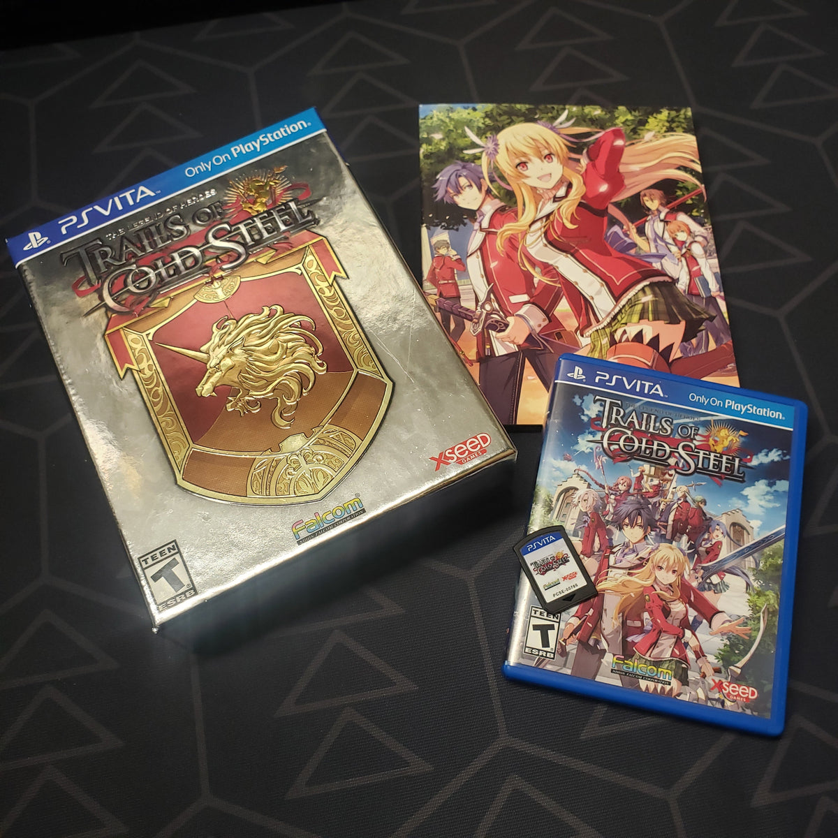 Image shows the outer box, art book, case and cartridge for the Lion Heart Edition of the video game The Legend of Heroes: Trails of Cold Steel for Playstation Vita
