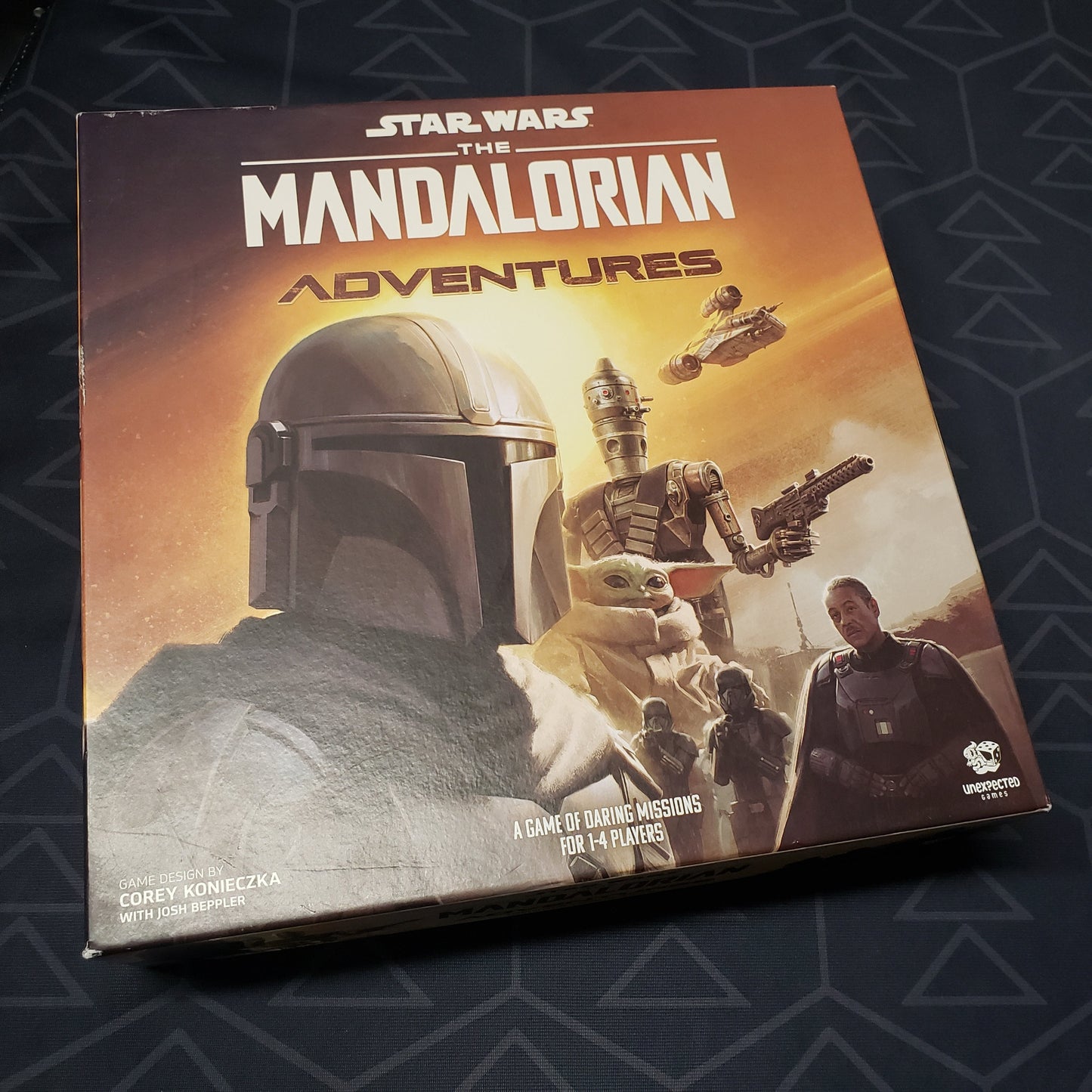 Image shows the front cover of the box for the The Mandalorian Adventures board game