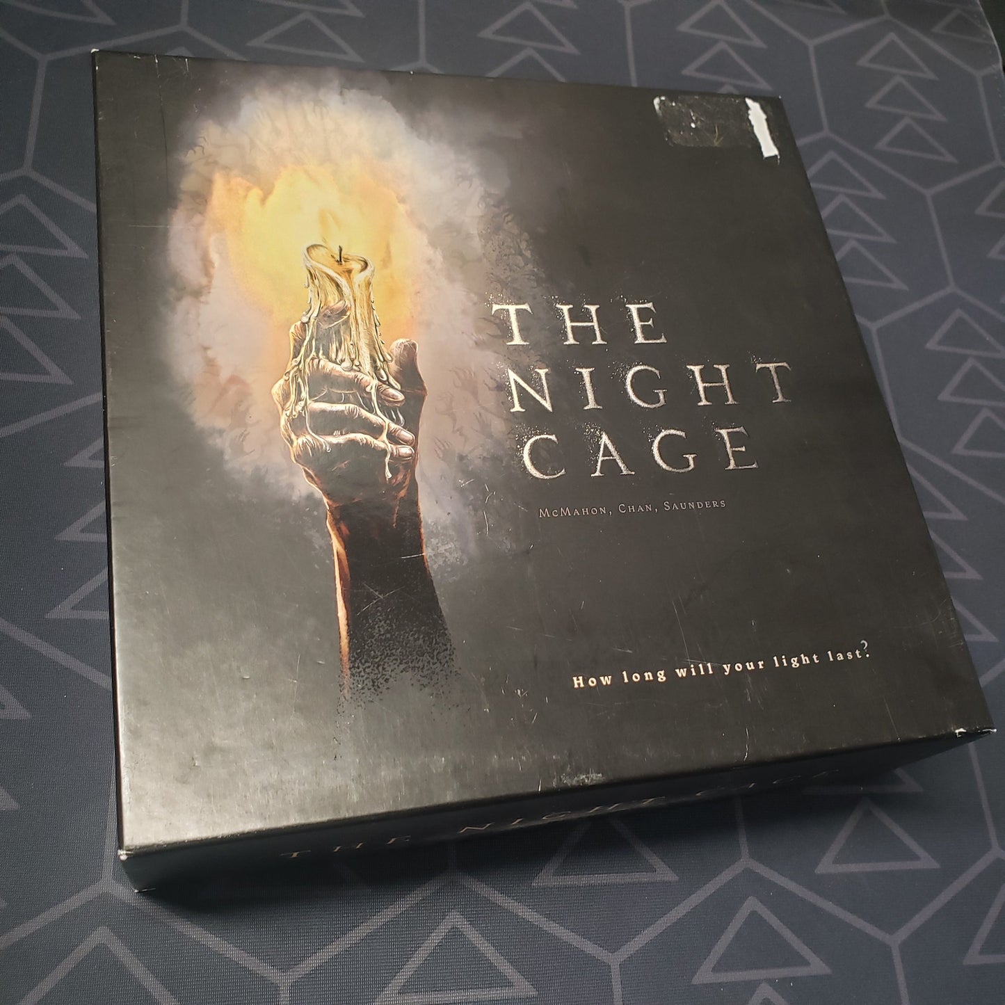 Image shows the front cover of the box of the Night Cage board game