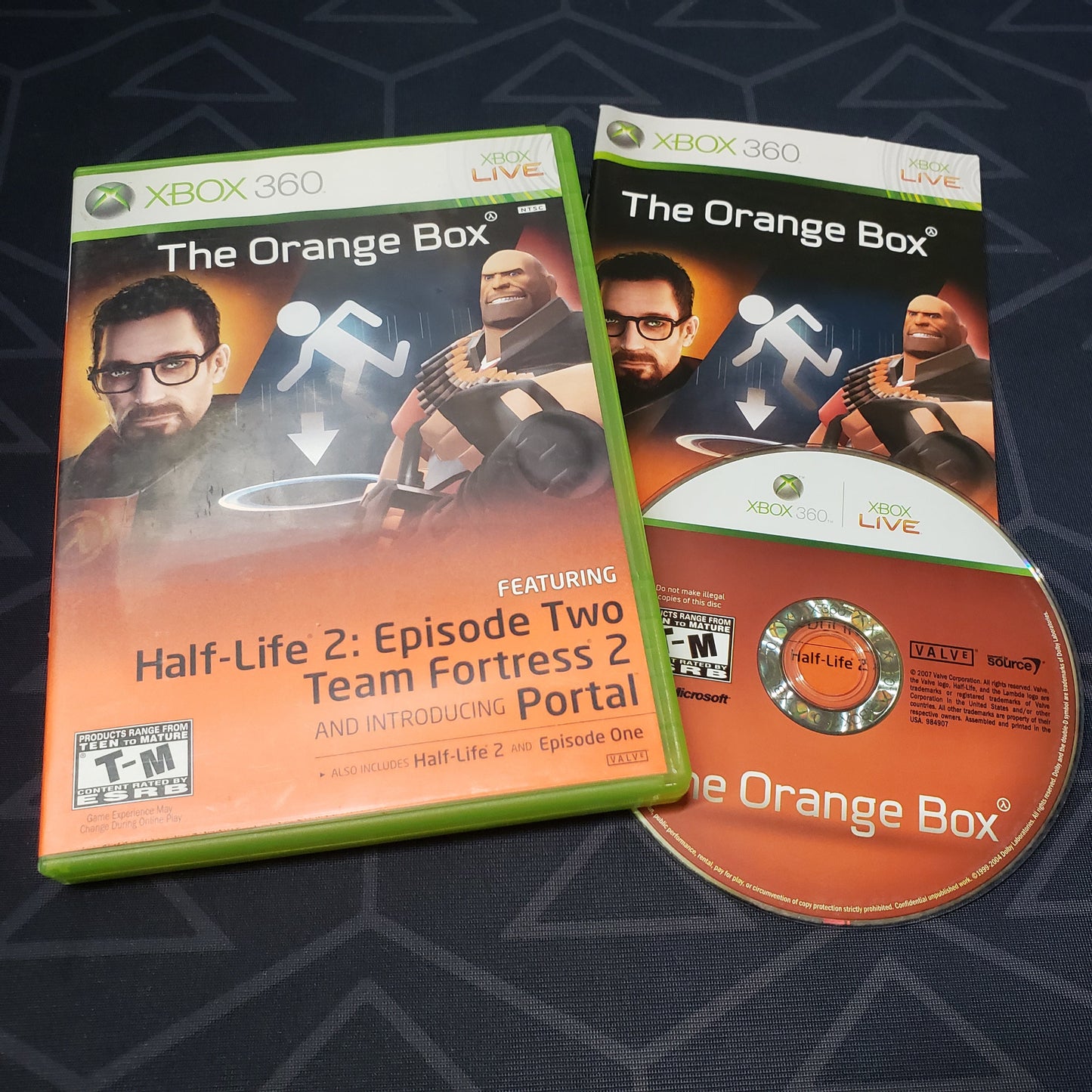 Image shows the case, manual and disc for the video game The Orange Box for Xbox 360