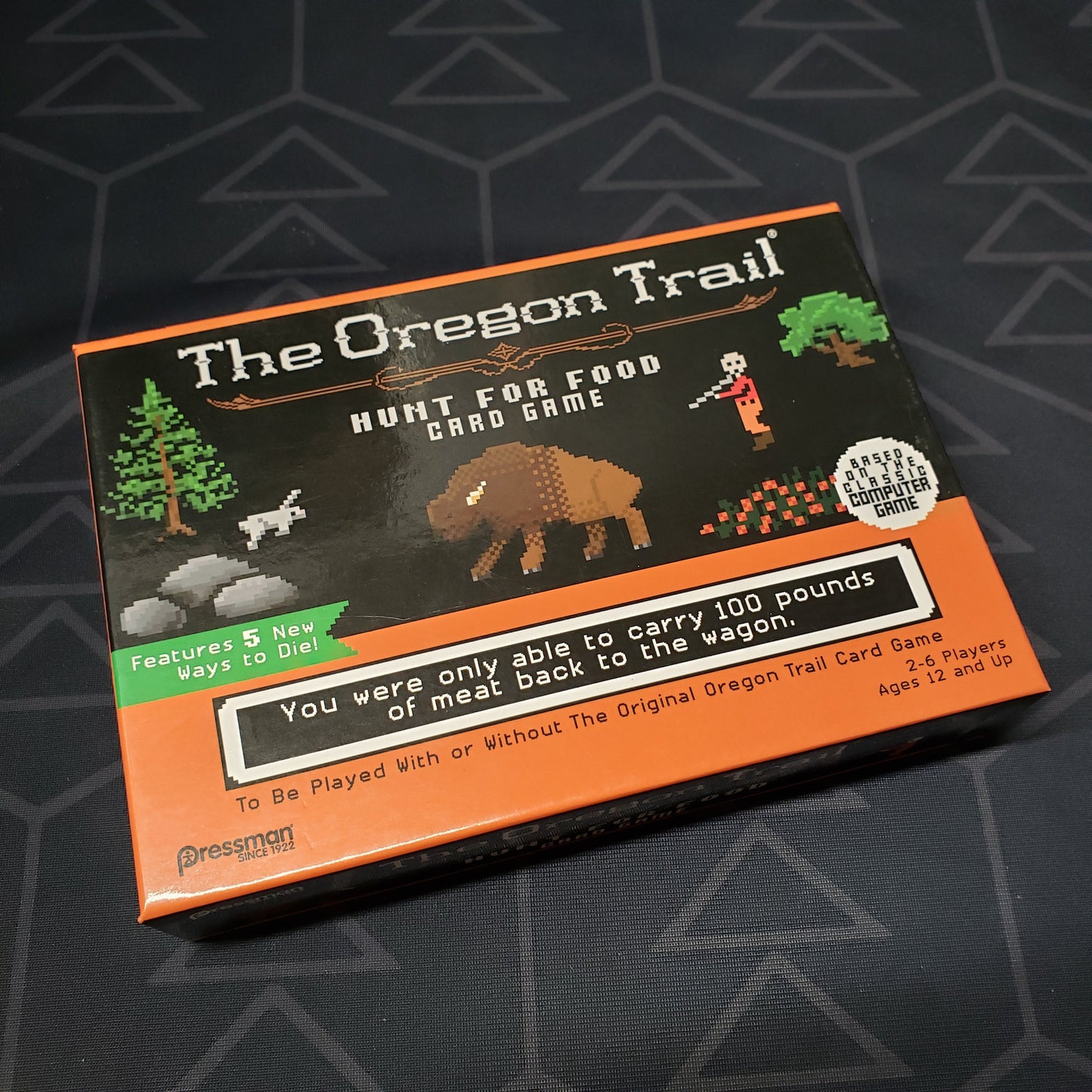 Image shows the front cover of the box of The Oregon Trail: Hunt for Food Card Game