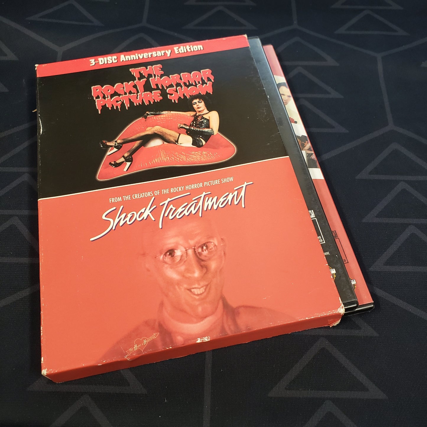 Image shows the outer box with cases sticking out for the 3-Disc Anniversary set of the movies The Rocky Horror Picture Show & Shock Treatment on DVD
