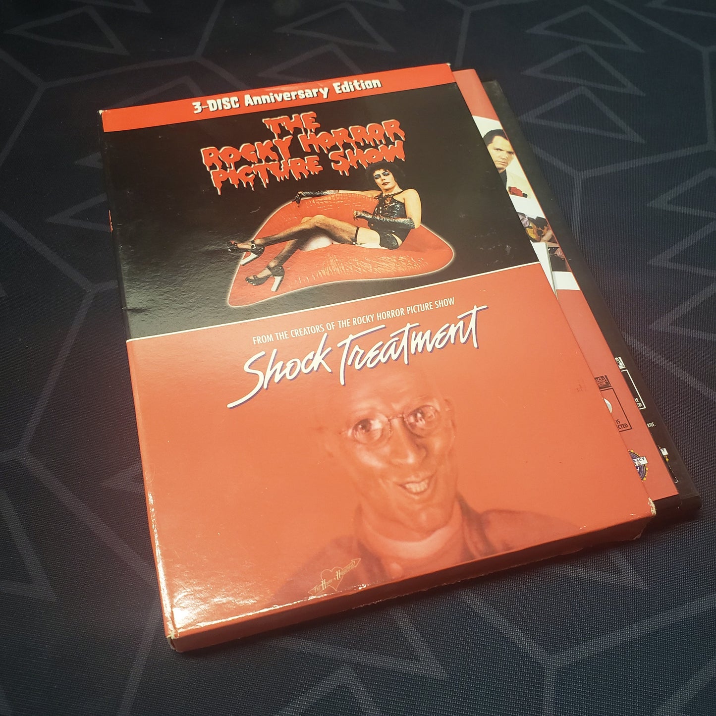 Image shows the outer box with cases sticking out for the 3-Disc Anniversary set of the movies The Rocky Horror Picture Show & Shock Treatment on DVD