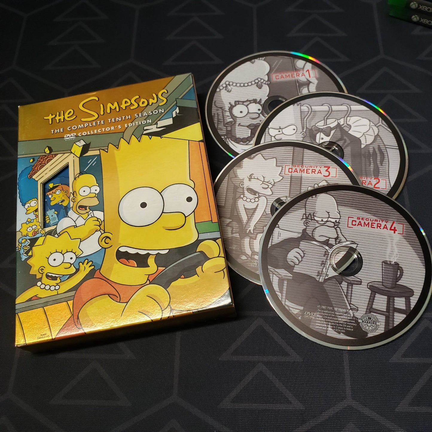 Image shows the case & four discs for the tenth season of The Simpsons on DVD