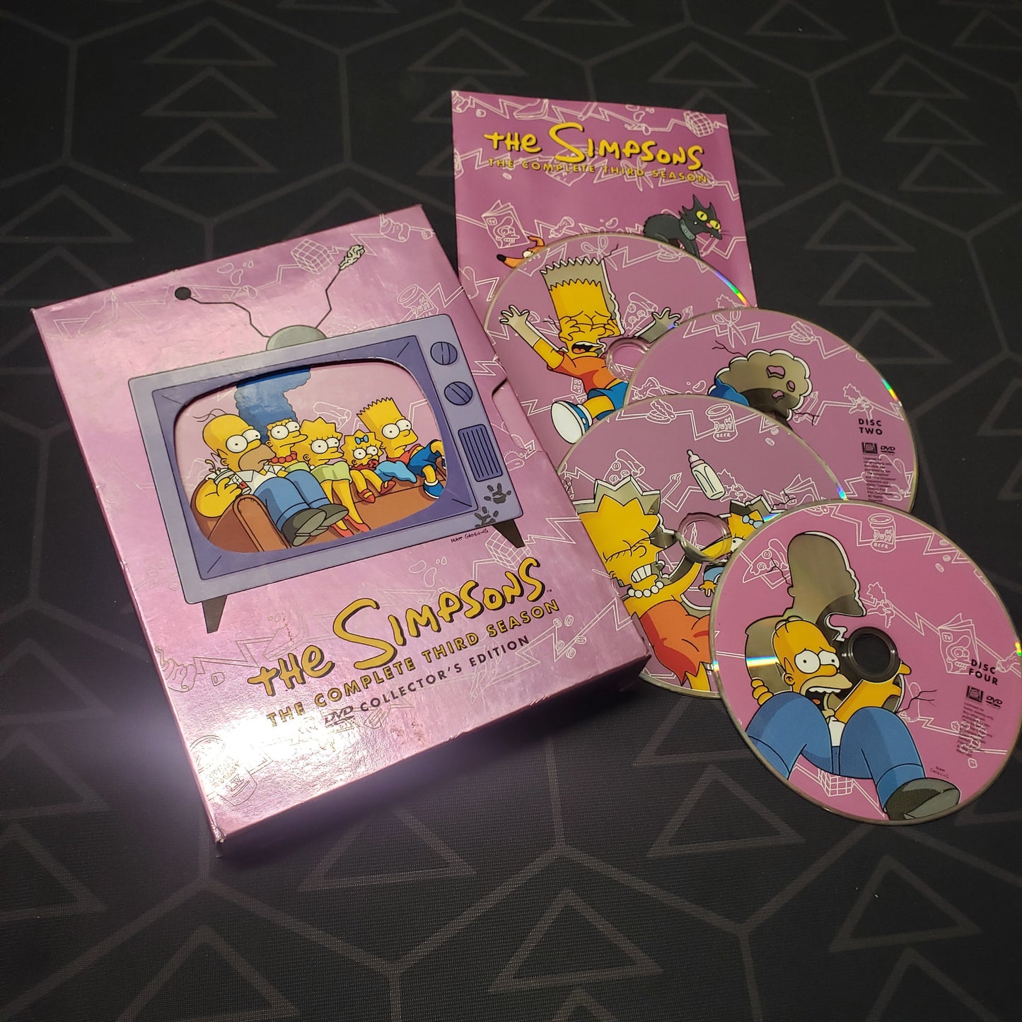 Image shows the case, booklet & four discs for the third season of The Simpsons on DVD