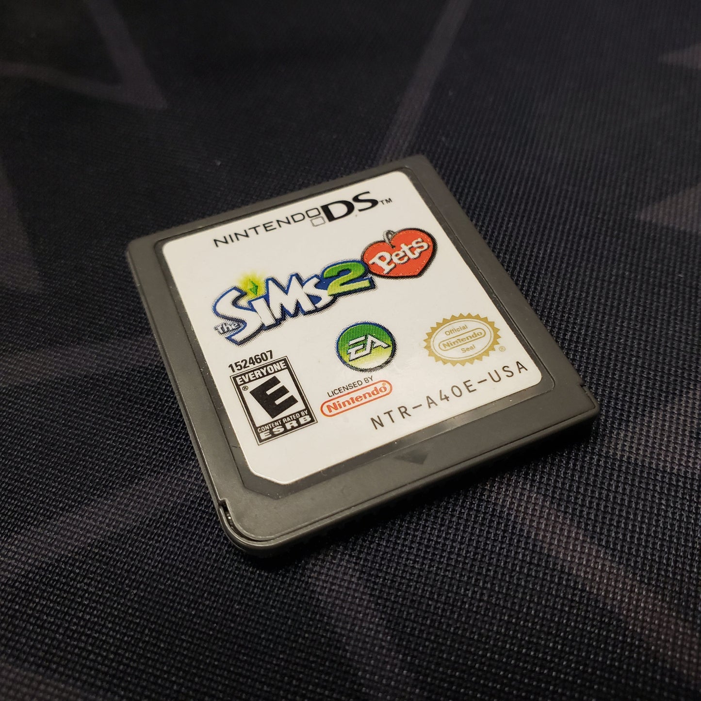 Image shows the front of the cartridge for the video game The Sims 2: Pets for Nintendo DS
