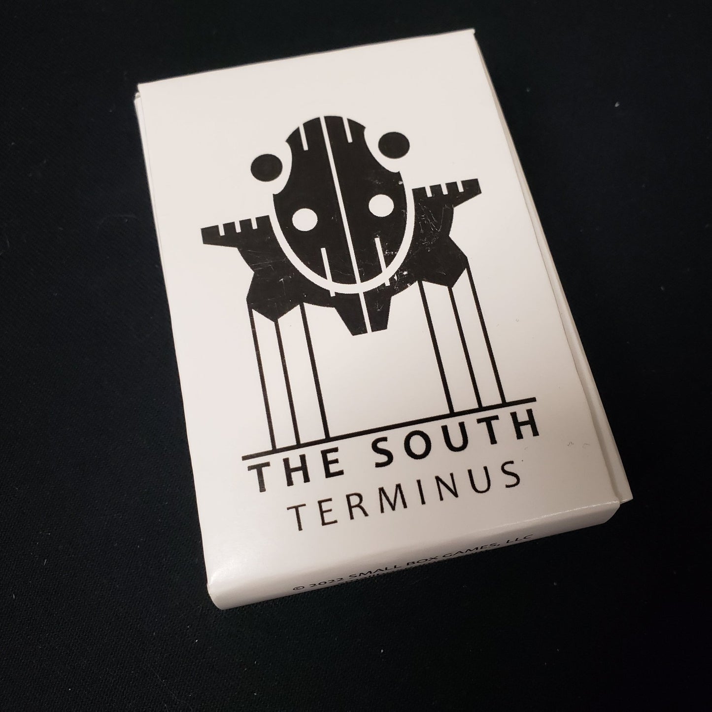 Image shows the front cover of the box of the South: Terminus card game