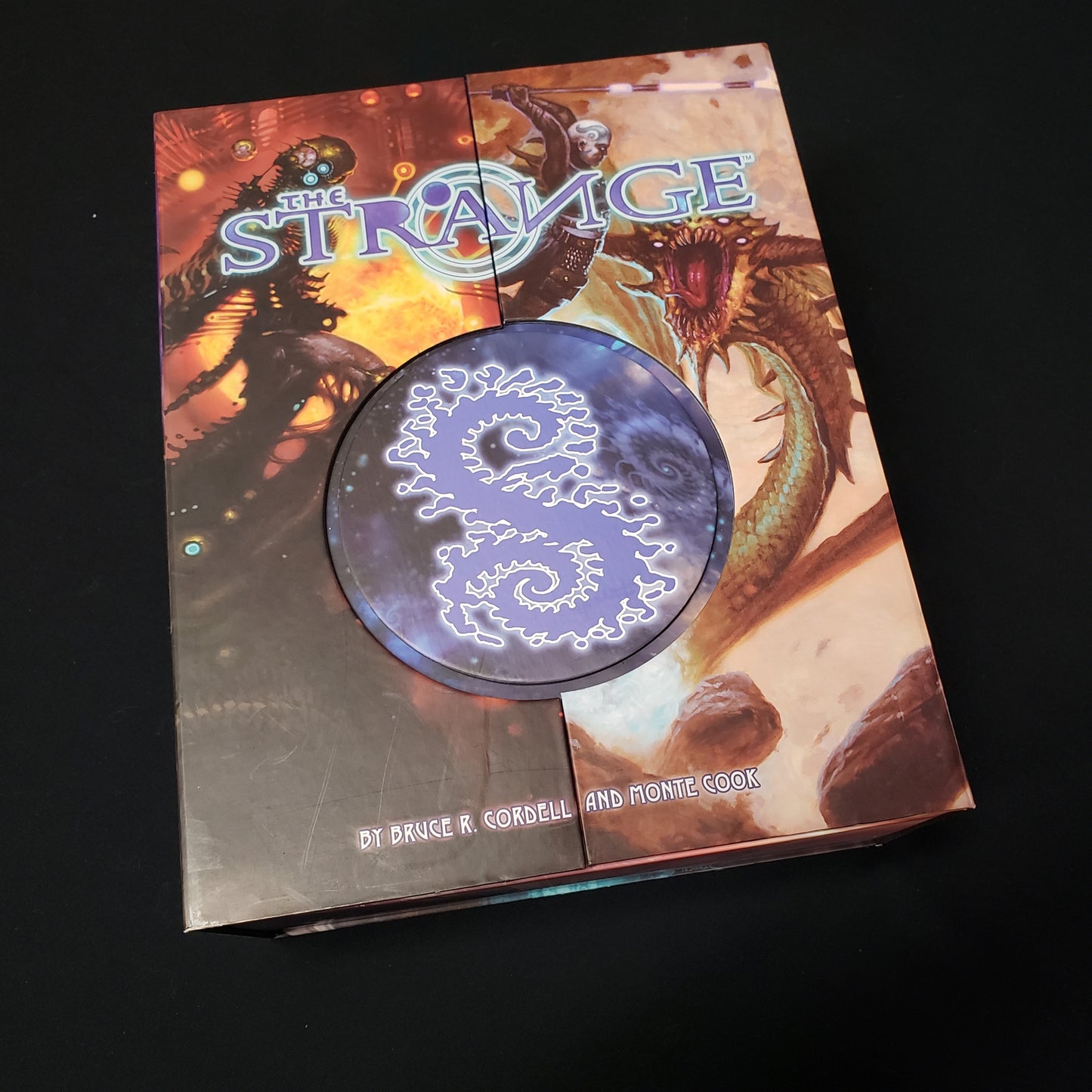 Image shows the front cover of the Strange Box Kickstarter edition of the Strange roleplaying game