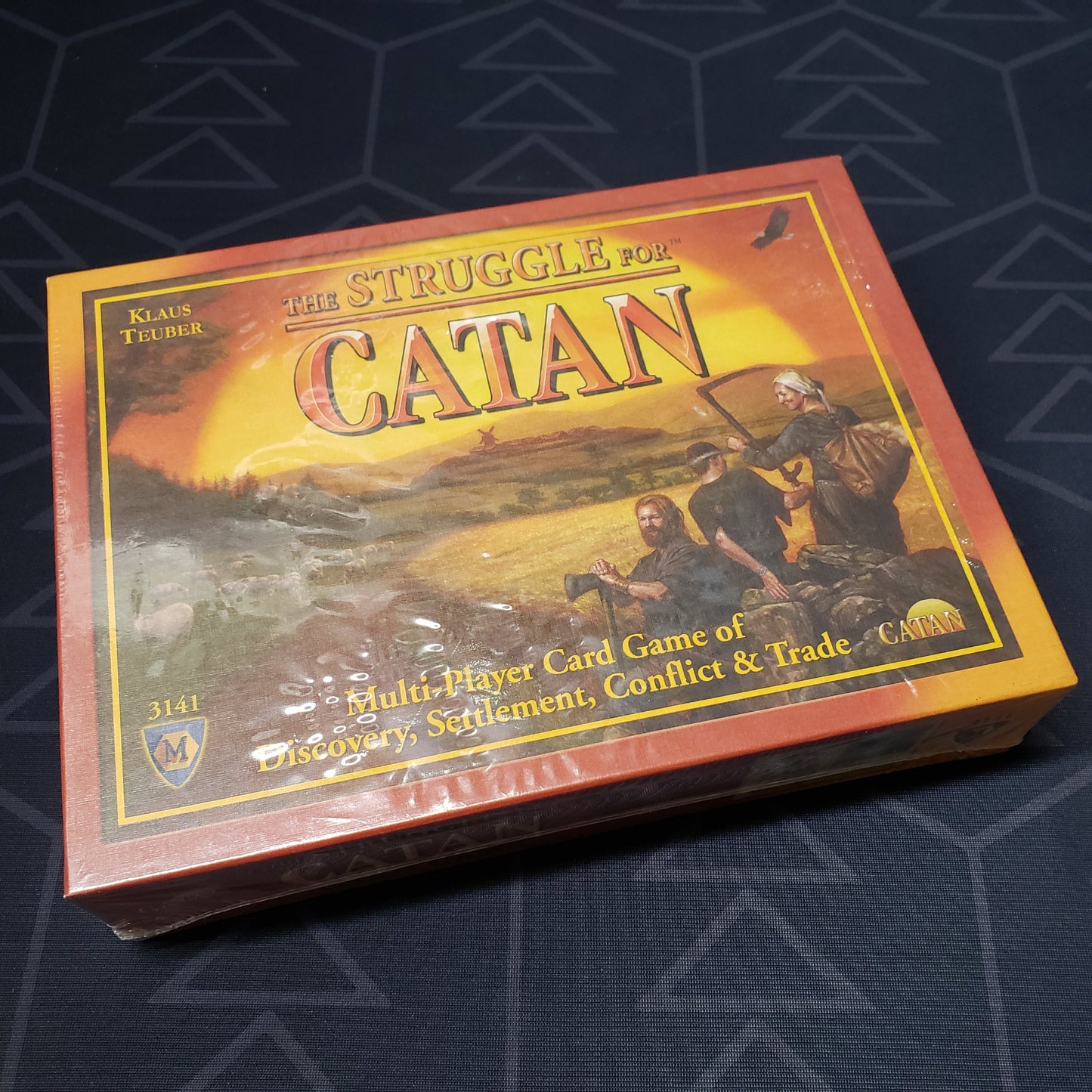Image shows the front cover of the box of the Struggle For Catan card game