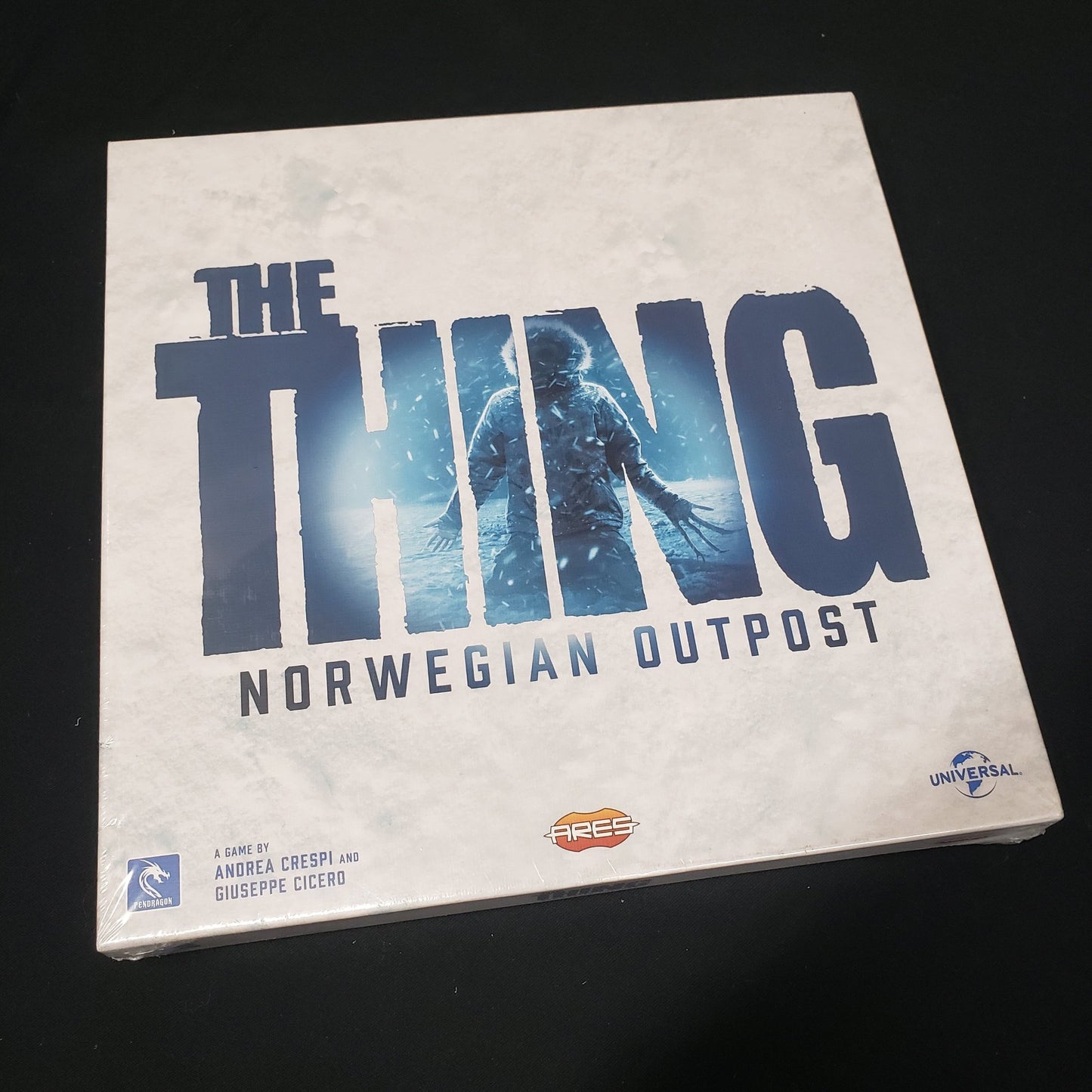 Image shows the front cover of the box of the Norwegian Outpost expansion for the board game The Thing