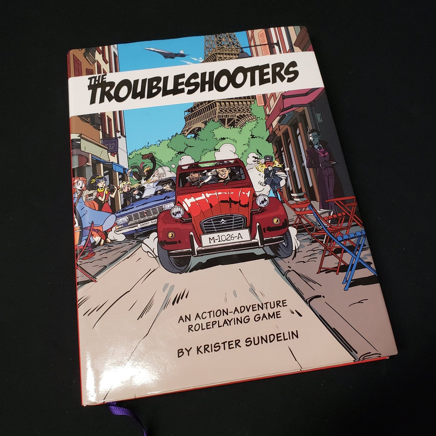 Image shows the front cover of the core rulebook for the roleplaying game The Troubleshooters