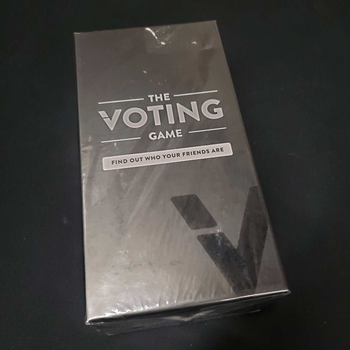Image shows the front cover of the box of the Voting Game card game
