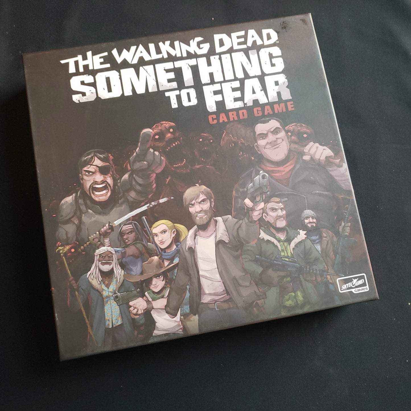Image shows the front cover of the box of the Walking Dead: Something to Fear card game