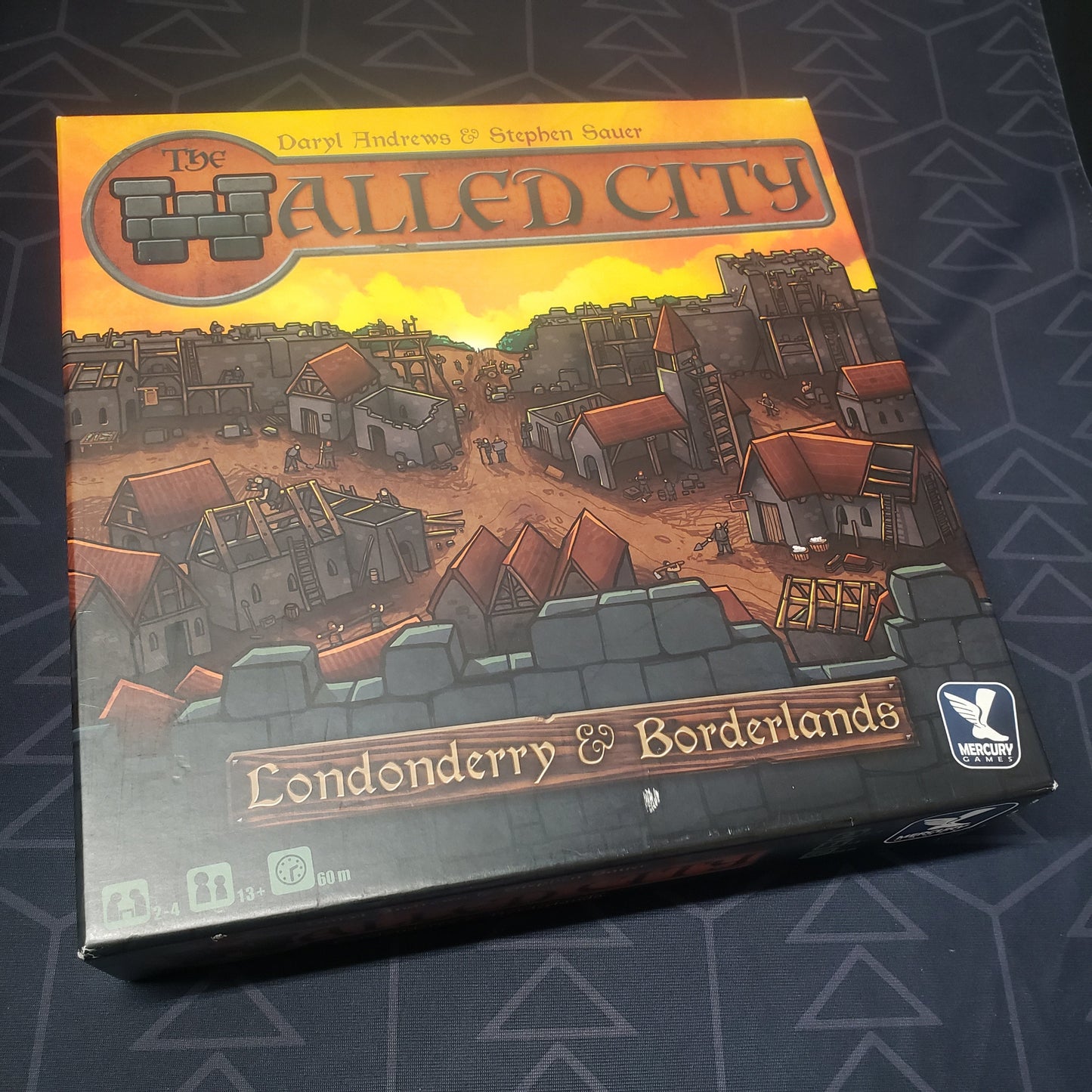 Image shows the front cover of the box of the Walled City board game