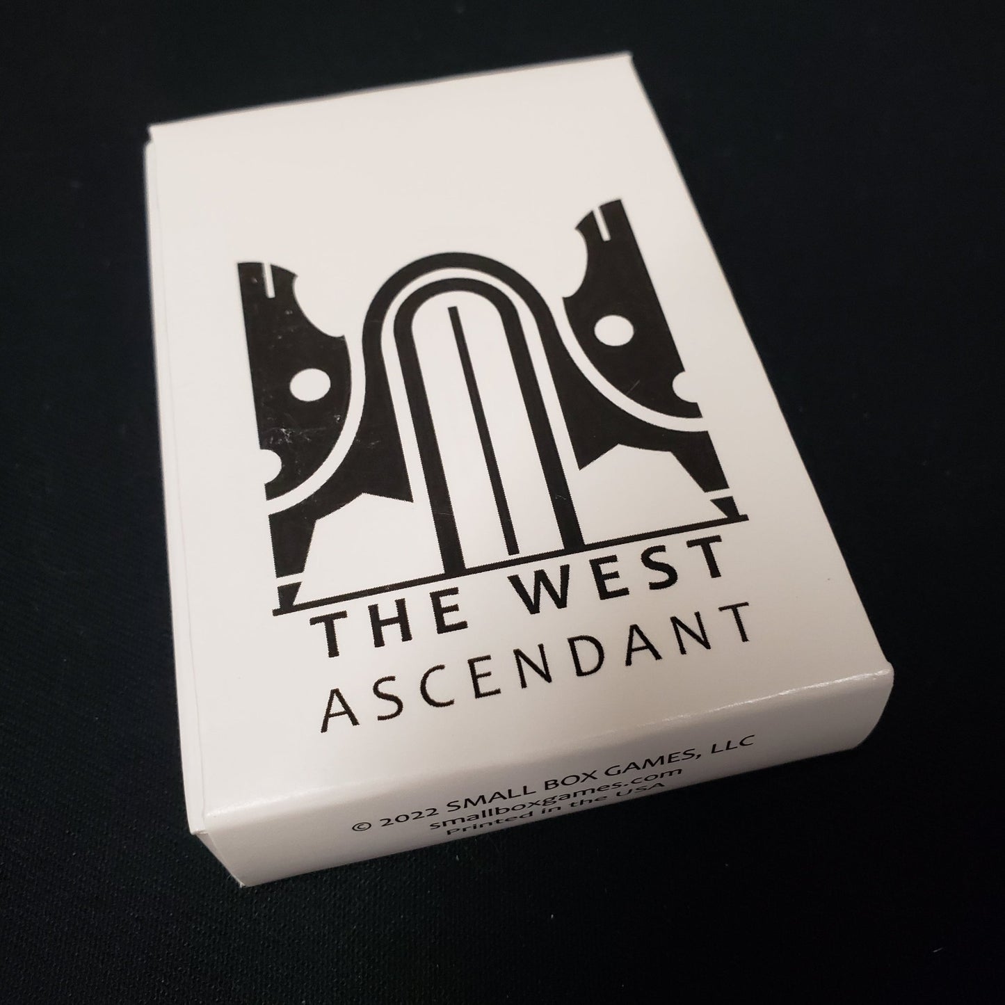 Image shows the front cover of the box of the West: Ascendant card game