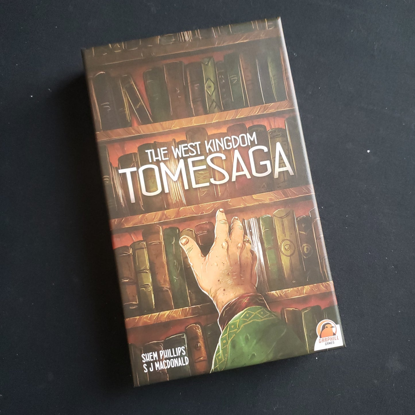 Image shows the front cover of the box of the West Kingdom Tomesaga board game expansion