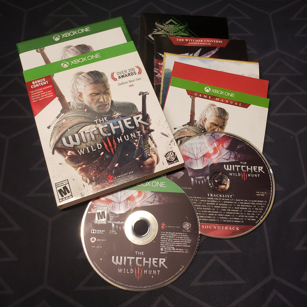 Image shows the case, sleeve, inserts and two discs for the video game The Witcher III: Wild Hunt for Xbox One