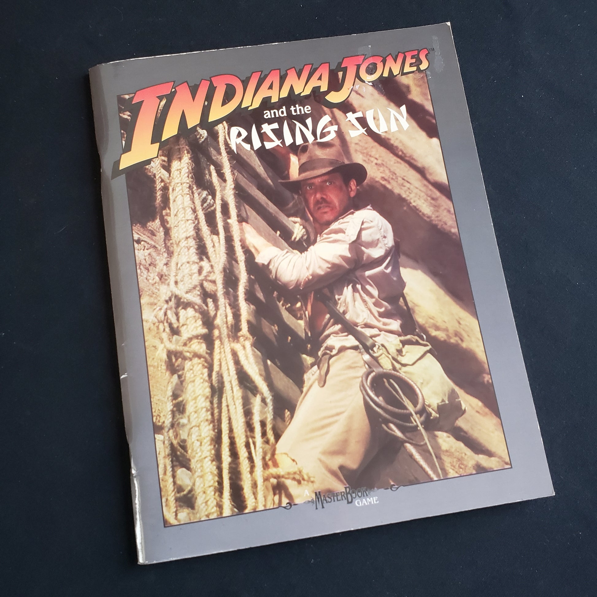 Image shows the front cover of the Indiana Jones and the Rising Sun book for the World of Indiana Jones roleplaying game