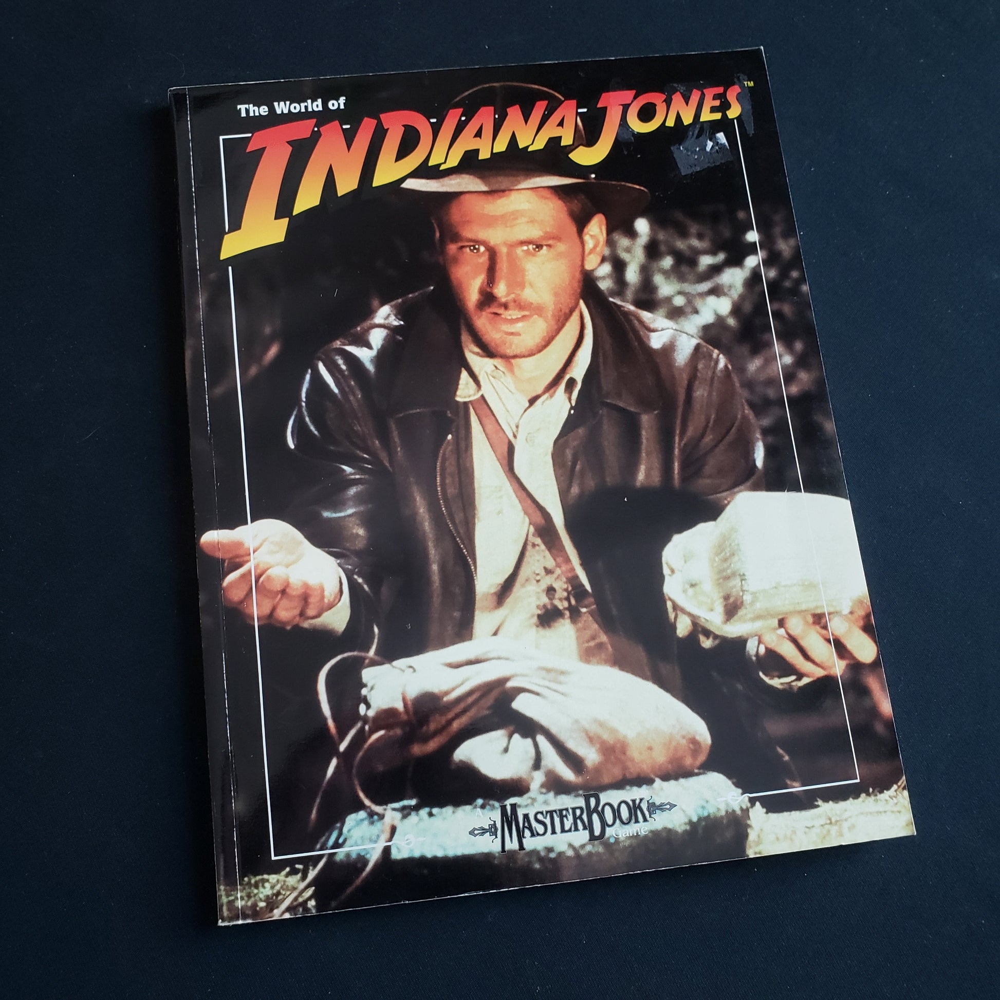 Image shows the front cover of the core rulebook for the World of Indiana Jones roleplaying game