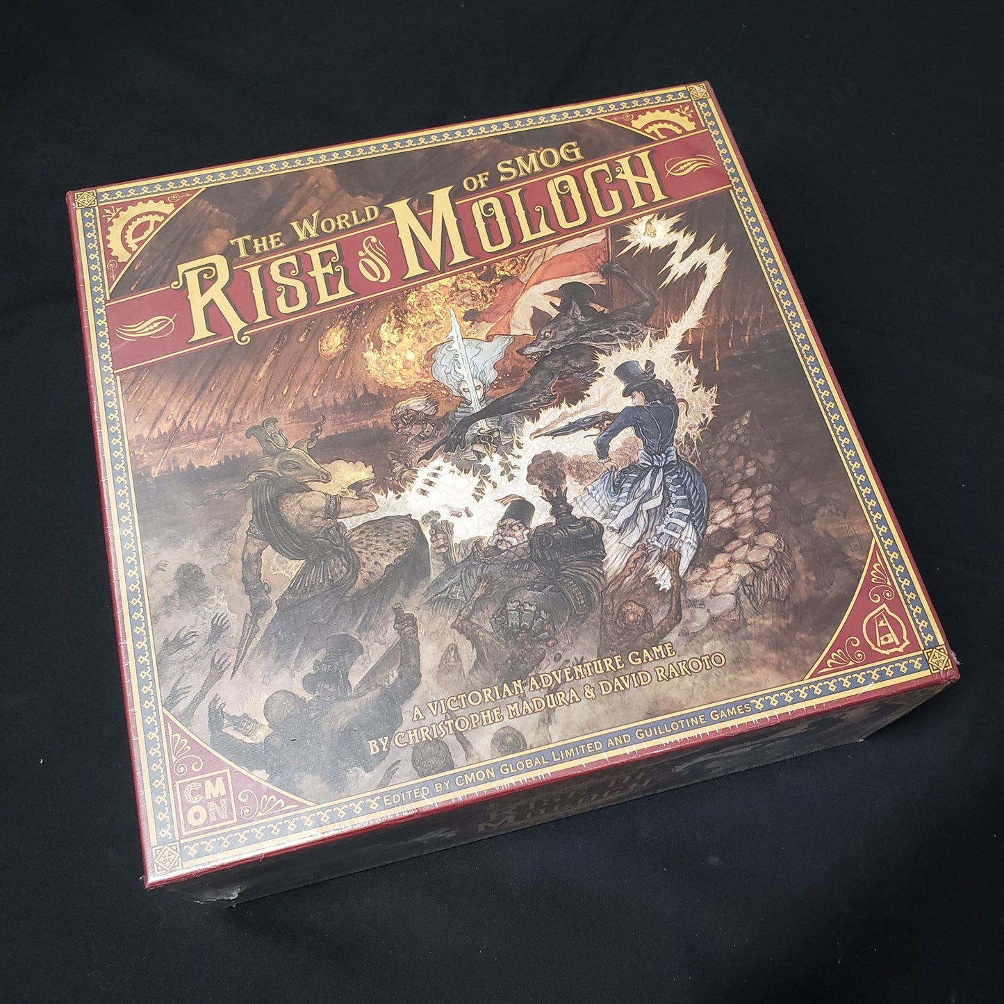 Image shows the front cover of the box of the World of SMOG: Rise of Moloch board game