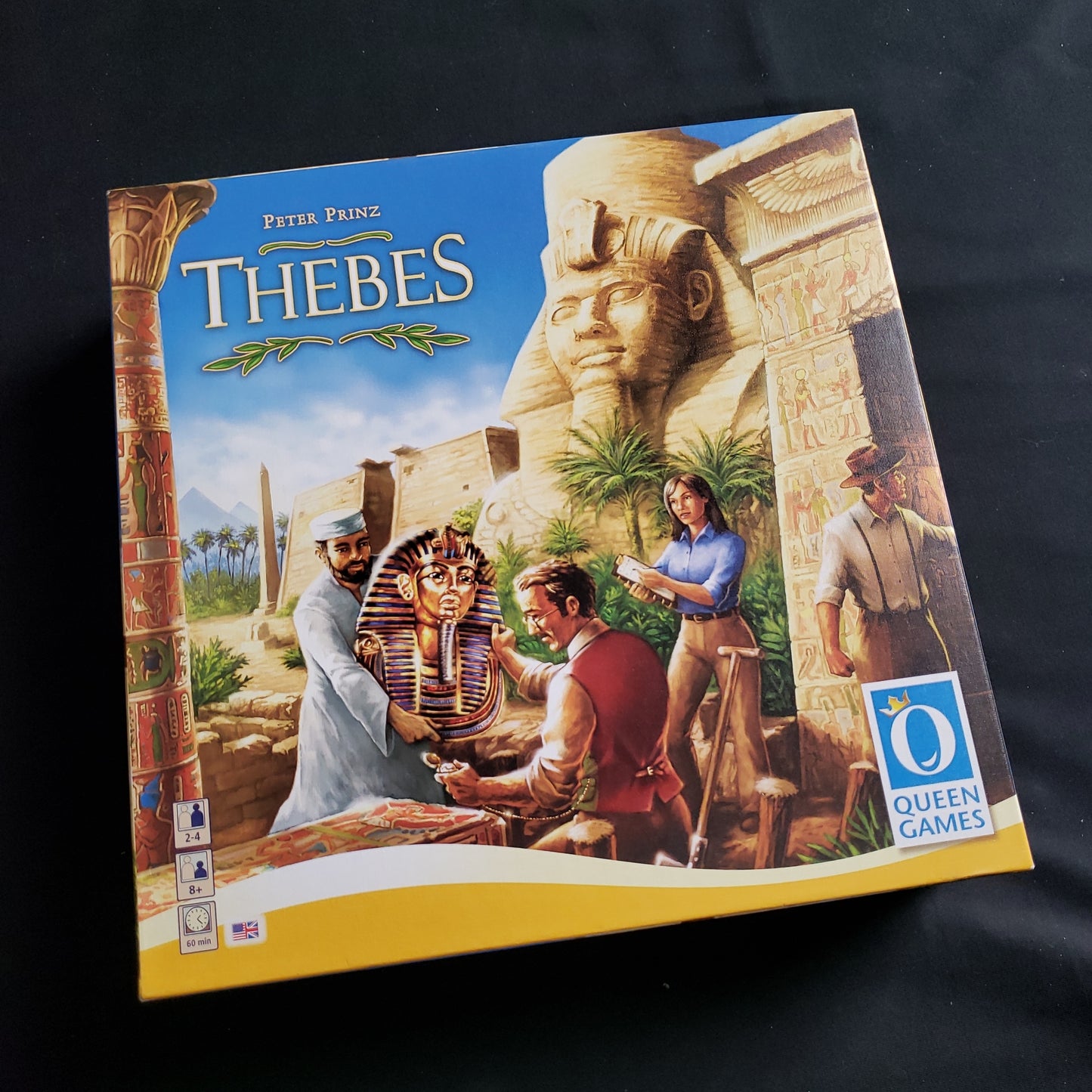 Image shows the front cover of the box of the Thebes board game