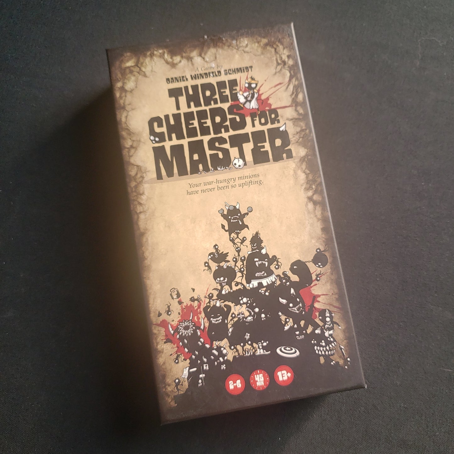 Image shows the front cover of the box of the Three Cheers for Master card game