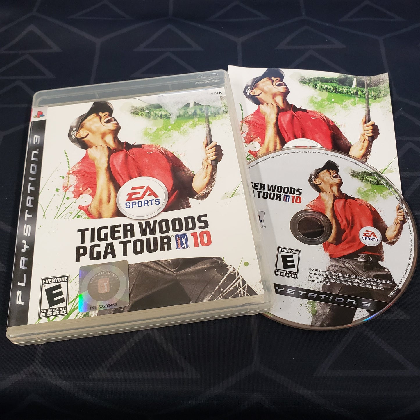 Image shows the case, manual and disc for the video game Tiger Woods PGA Tour 10 for Playstation 3