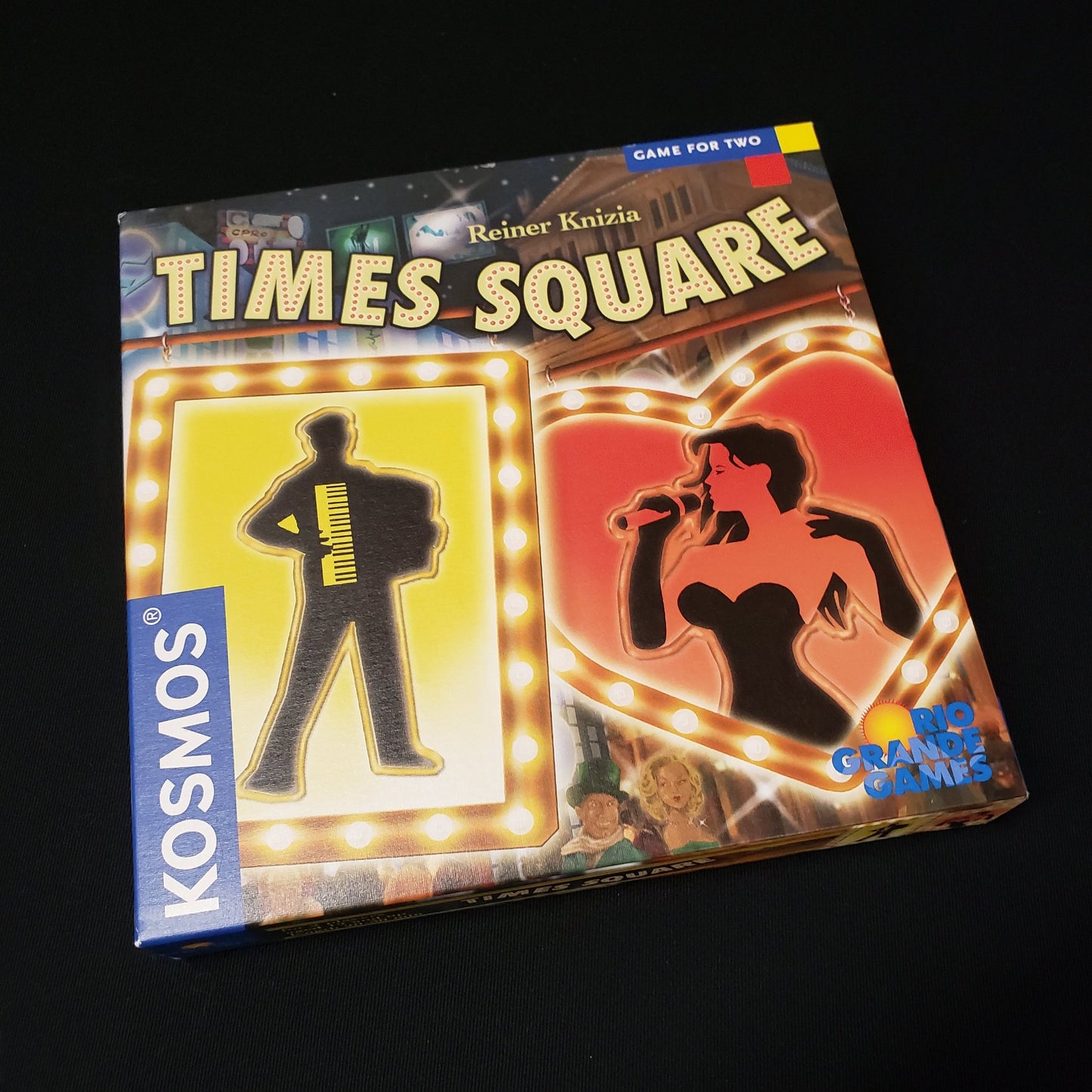 Image shows the front cover of the box of the Times Square board game