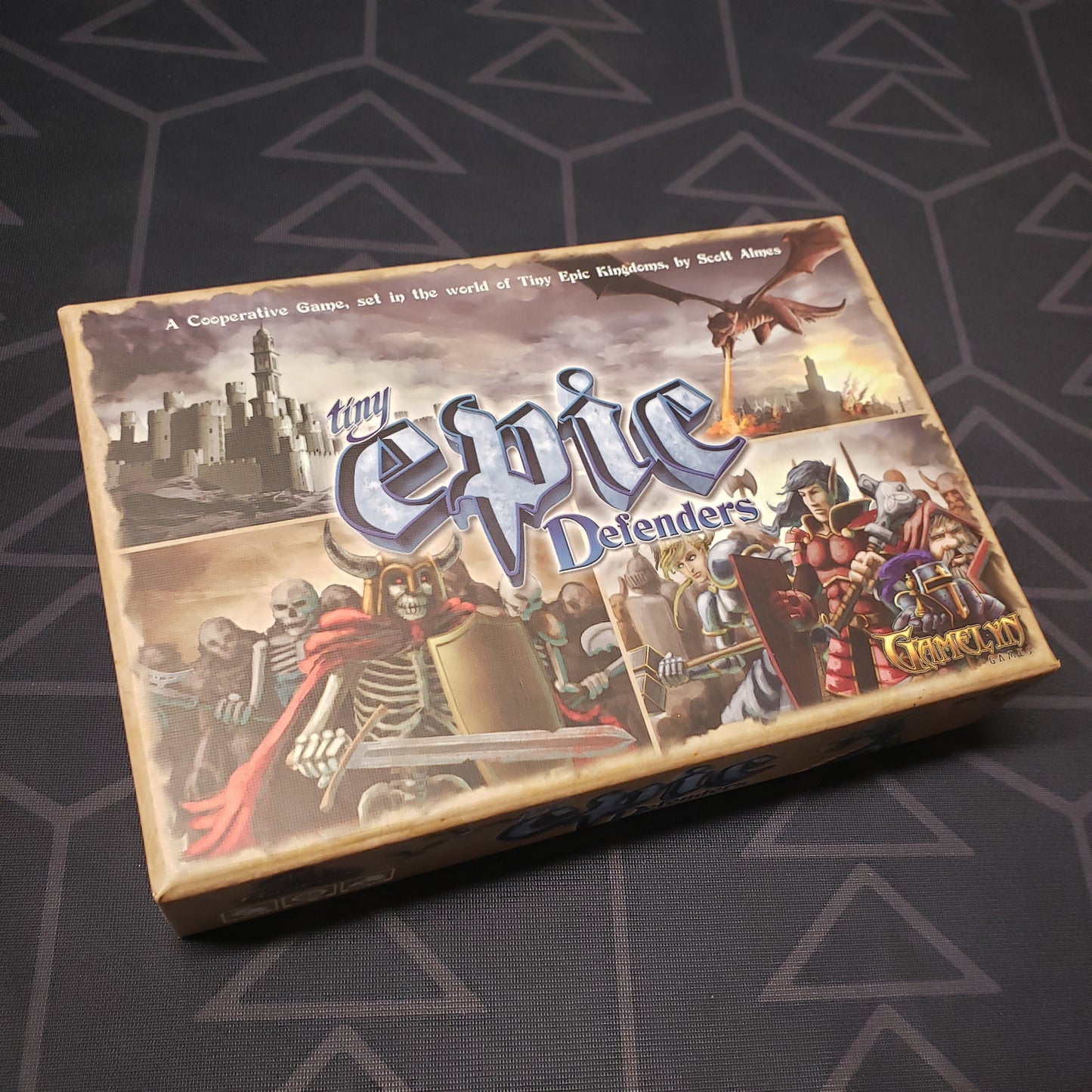 Image shows the front cover of the box of the Tiny Epic Defenders board game