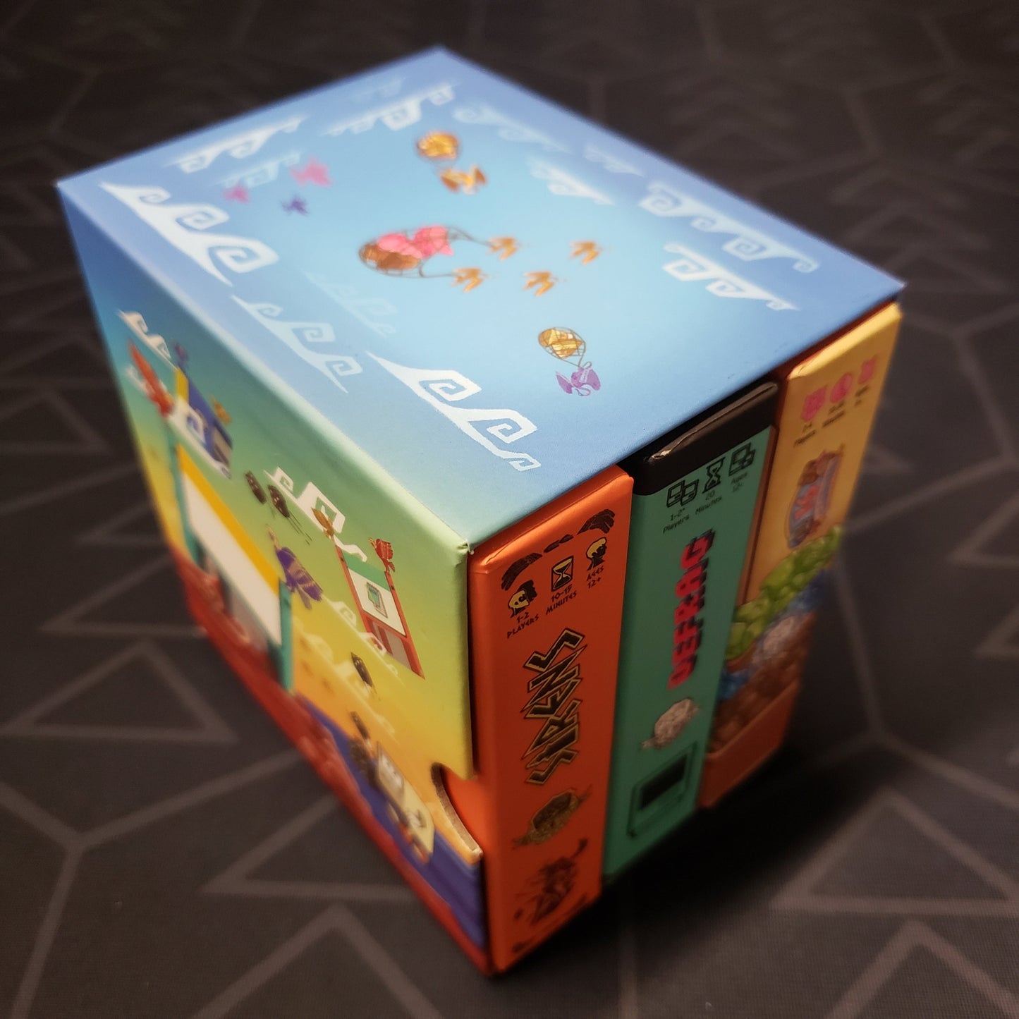 Image shows the outer box of the Tiny Game Series: Volume 1 set of board games