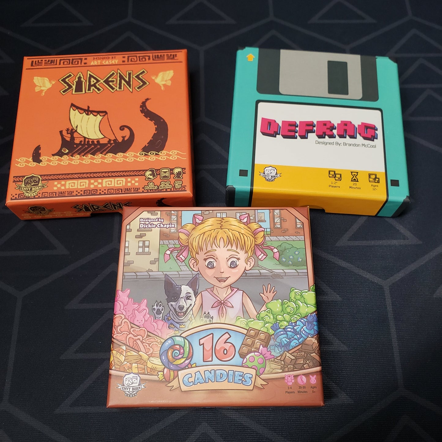 Image shows the boxes of the three games that make up the Tiny Game Series: Volume 1 set of board games